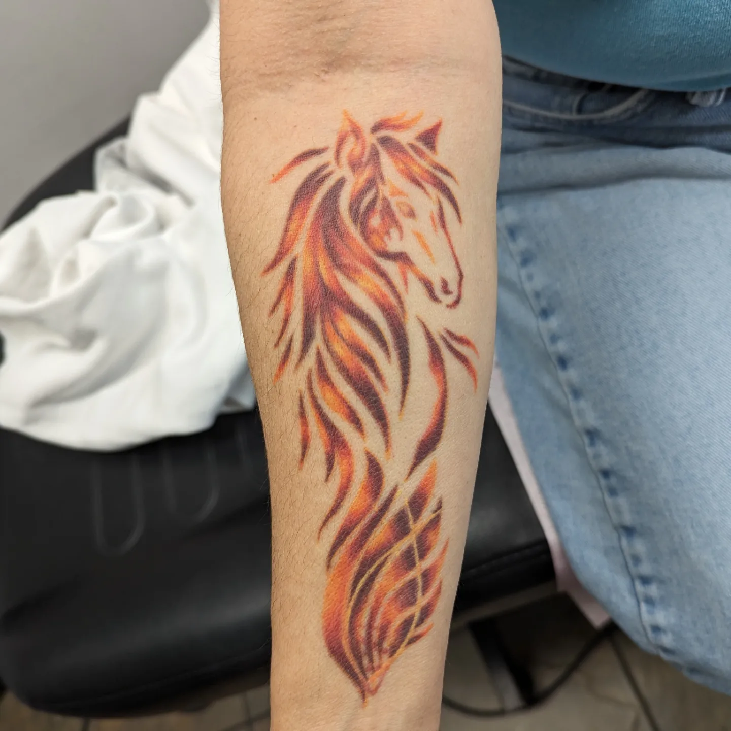 Flame horse new school tattoo on the forearm by Lorelei