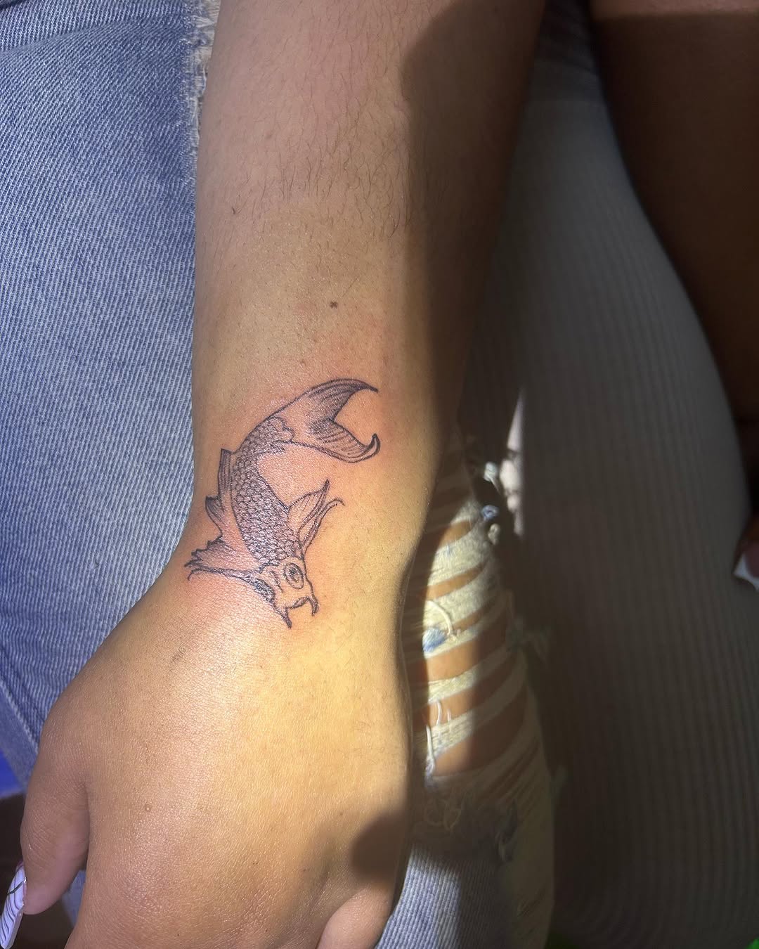 Koi fish fine line tattoo on the forearm by ๐ฆ