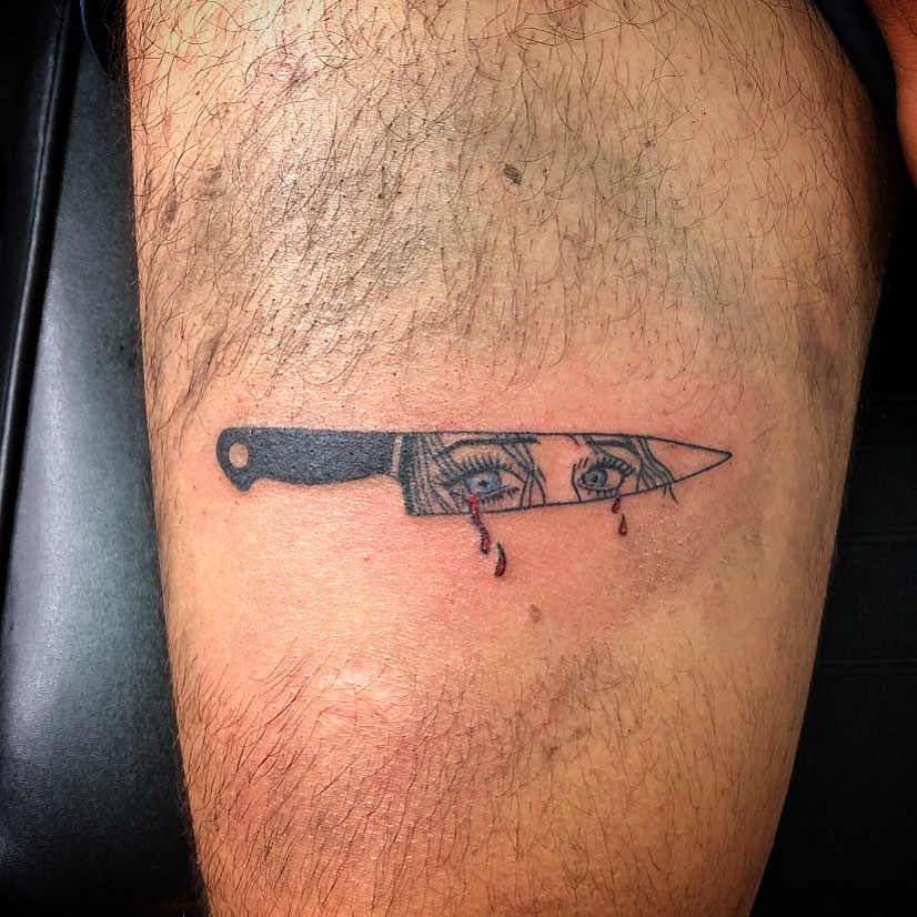 Knife with eyes realism tattoo on the thigh by Tattoos by Marcy