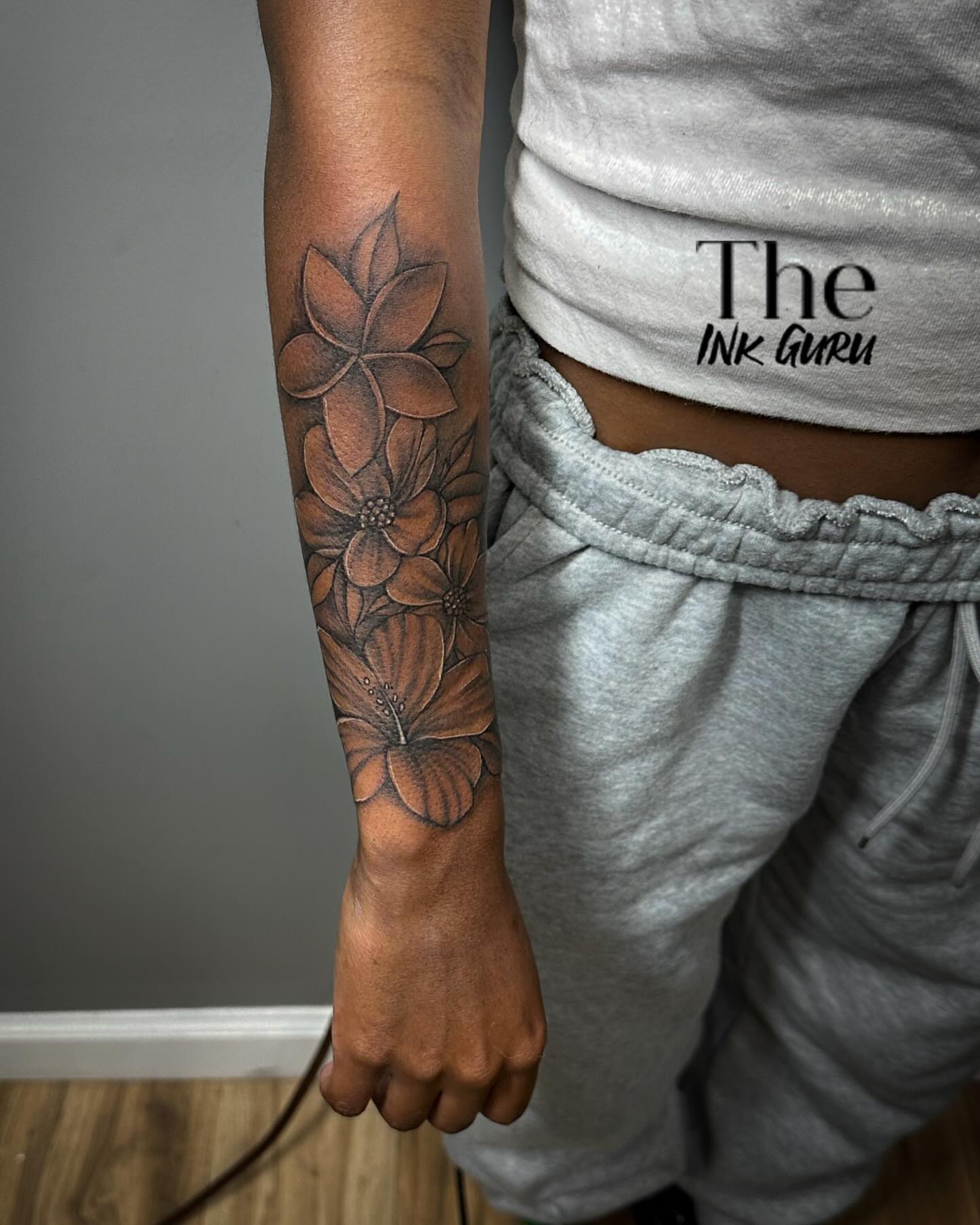 Floral arrangement black and grey tattoo on the forearm by The Ink Guru.