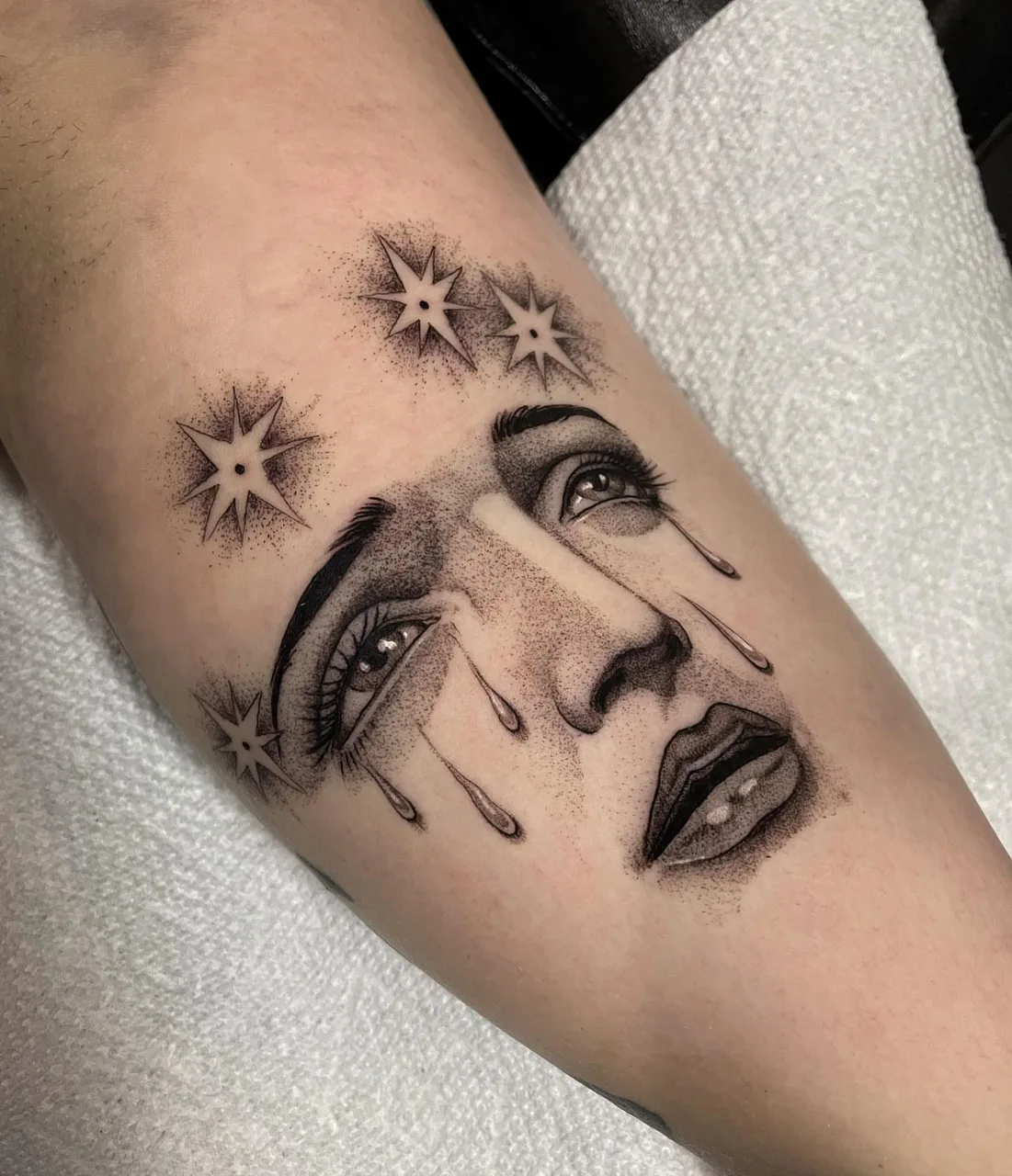 Tearful face dotwork tattoo on the forearm by Lauren Vandevier