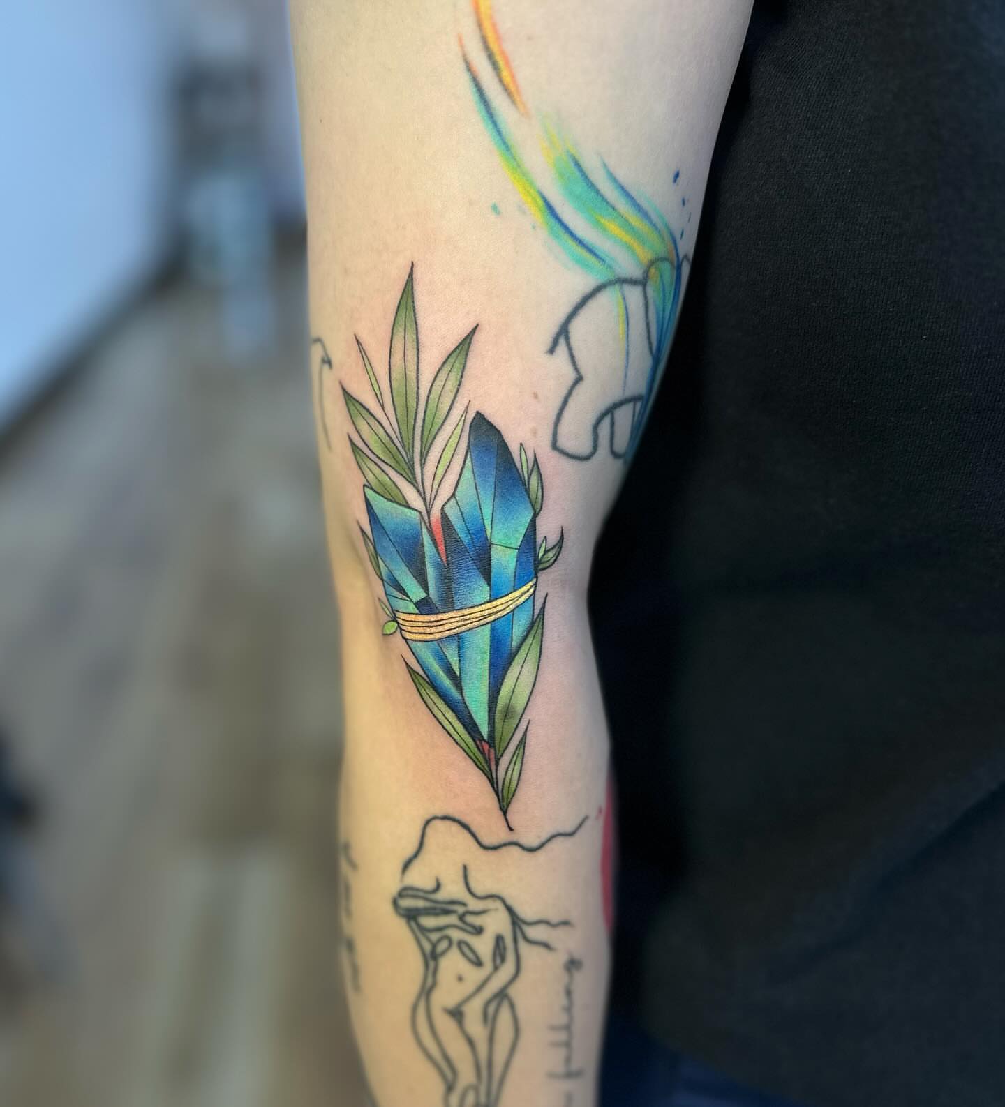 Gemstone and leaves watercolor tattoo on the forearm by alex h🪴 neotrad