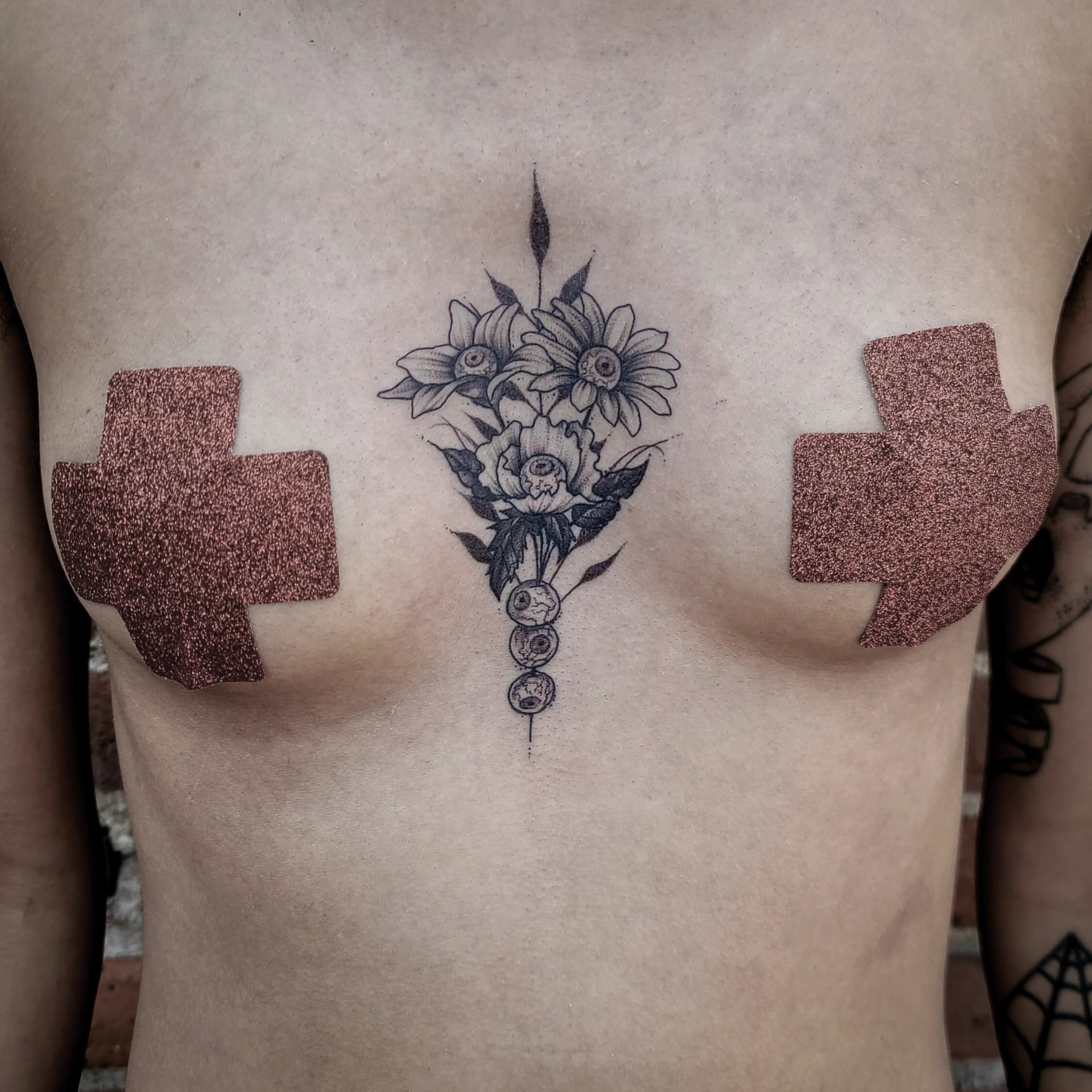 Flower bouquet dotwork tattoo on the chest by Gail Howard Perry III