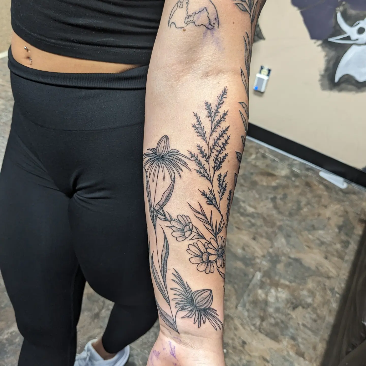 Botanical black and grey tattoo on the forearm by Kara Falcon
