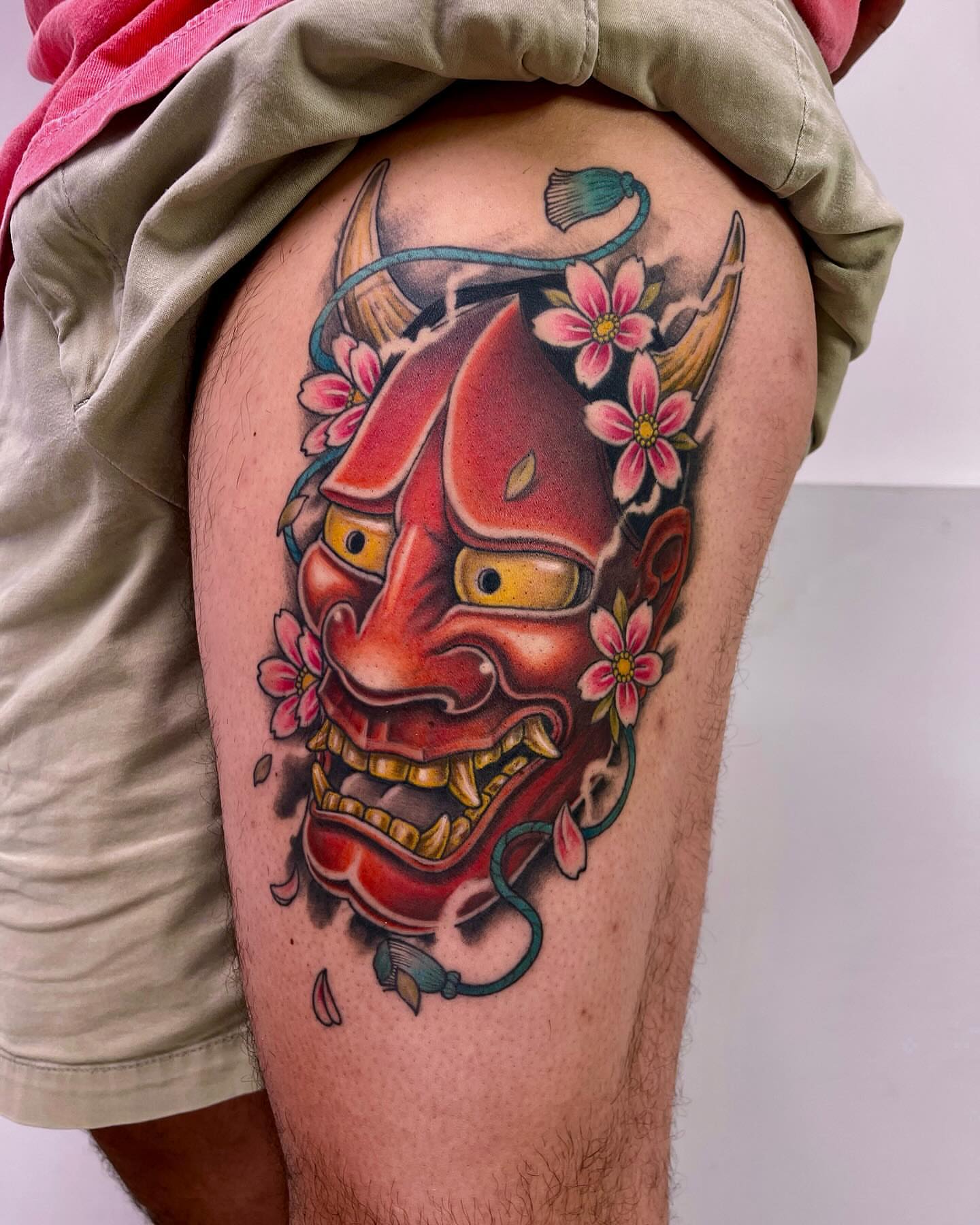 Demon mask with flowers japanese irezumi tattoo on the thigh by Michigan Tattoo Artist