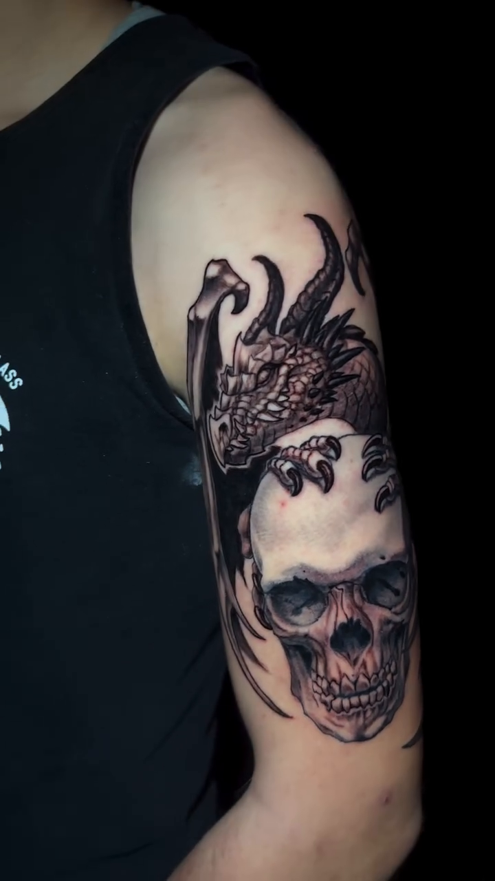 Skull and dragon dark realism tattoo by shane baker