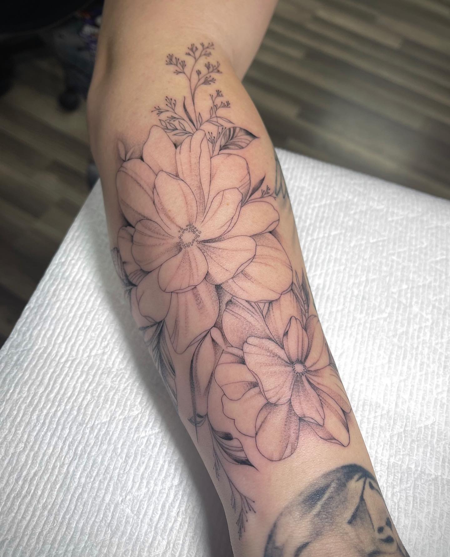 Flowers black and grey tattoo on the forearm by Beans