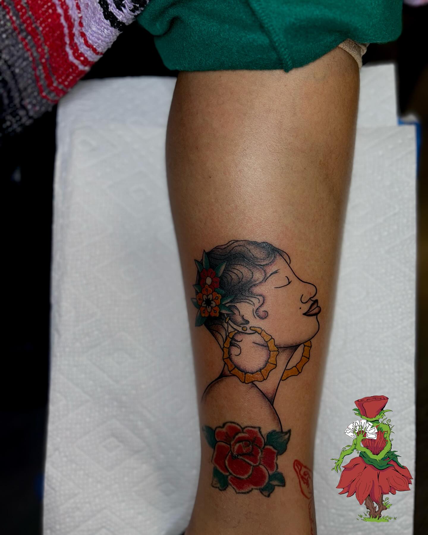 Woman with flowers American traditional tattoo on the forearm by Marques Neal