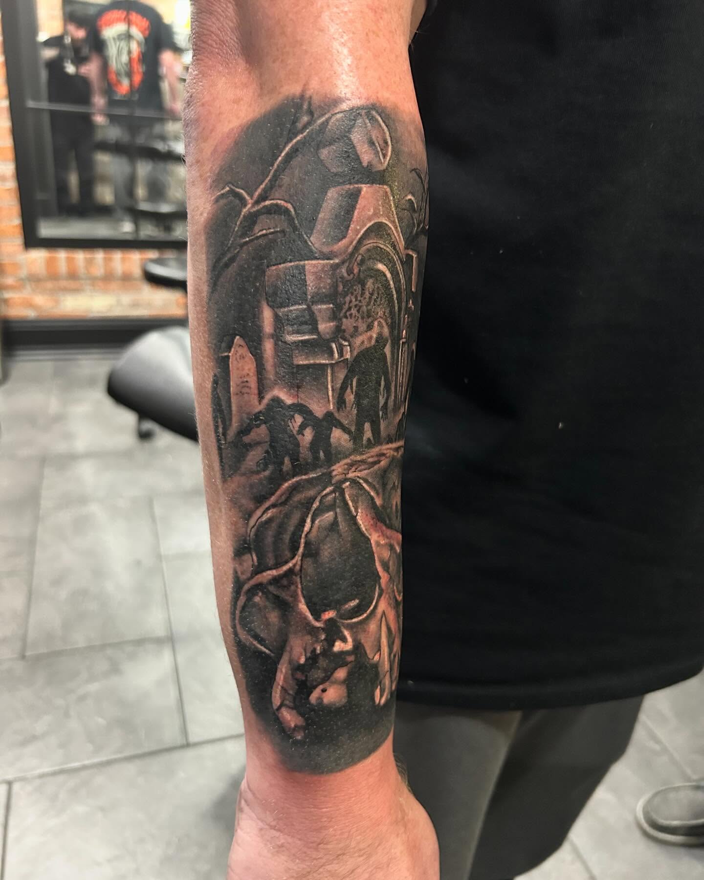 Motorcycle and skulls realism tattoo on the forearm by Brian Keith
