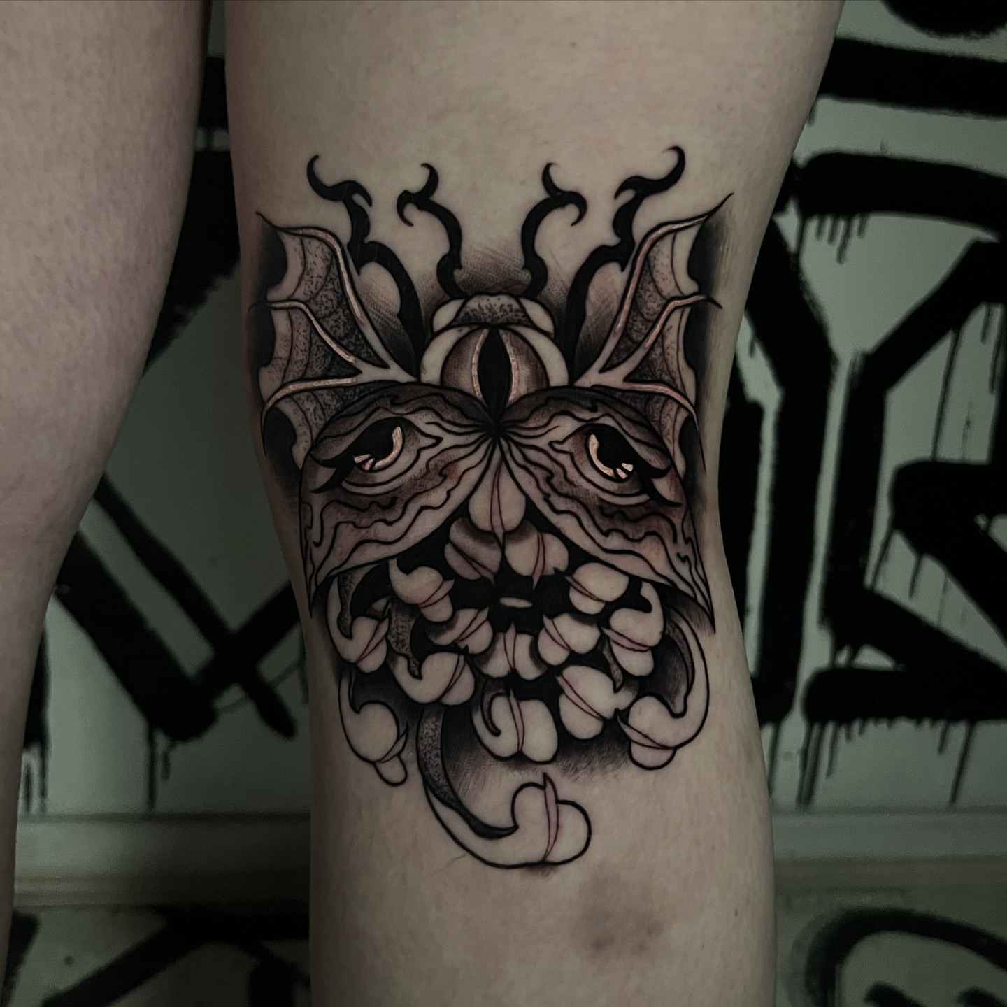 Demon face dark realism tattoo on the thigh by Brittney