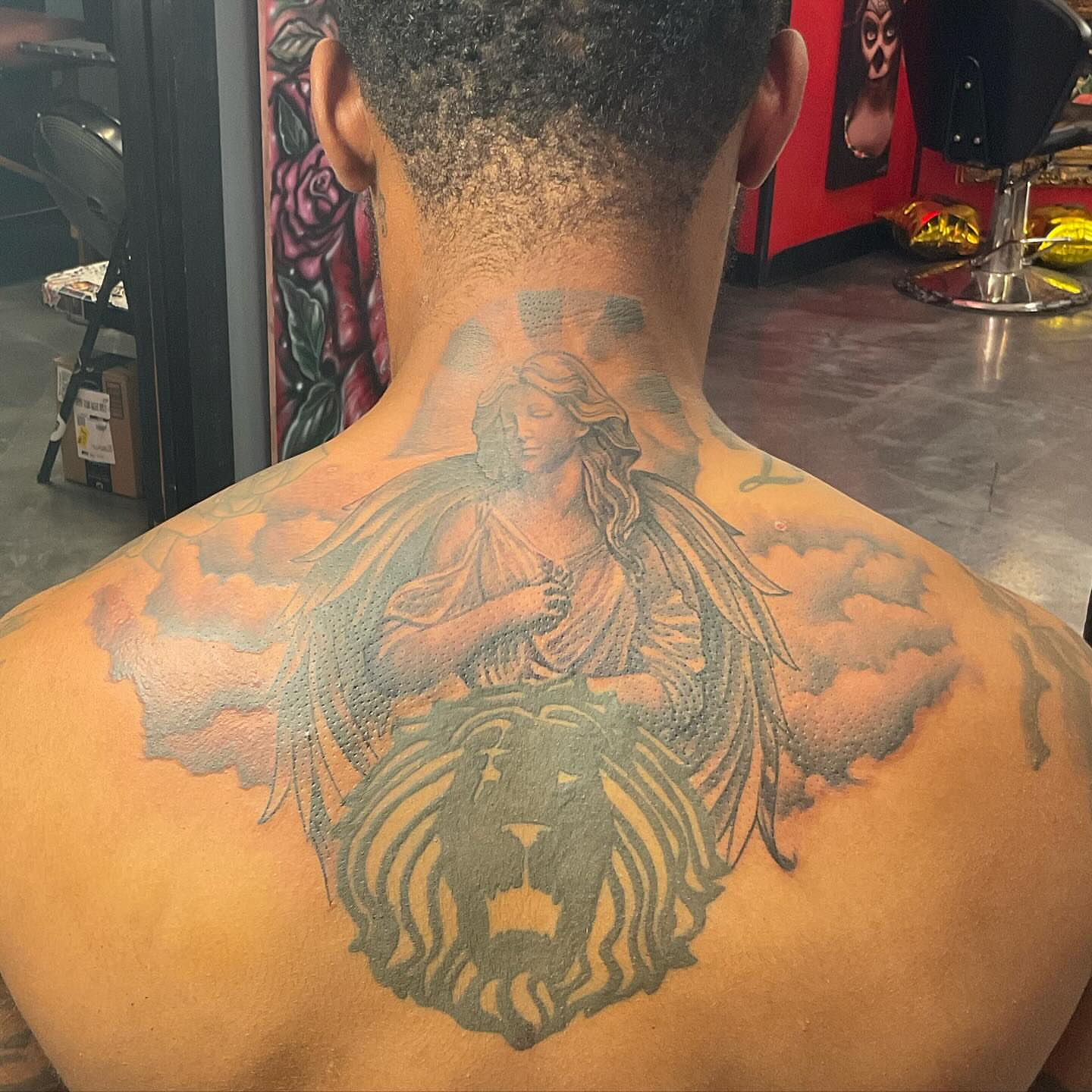 Angel with lion black and grey tattoo on the back by Alejandro Zaragoza