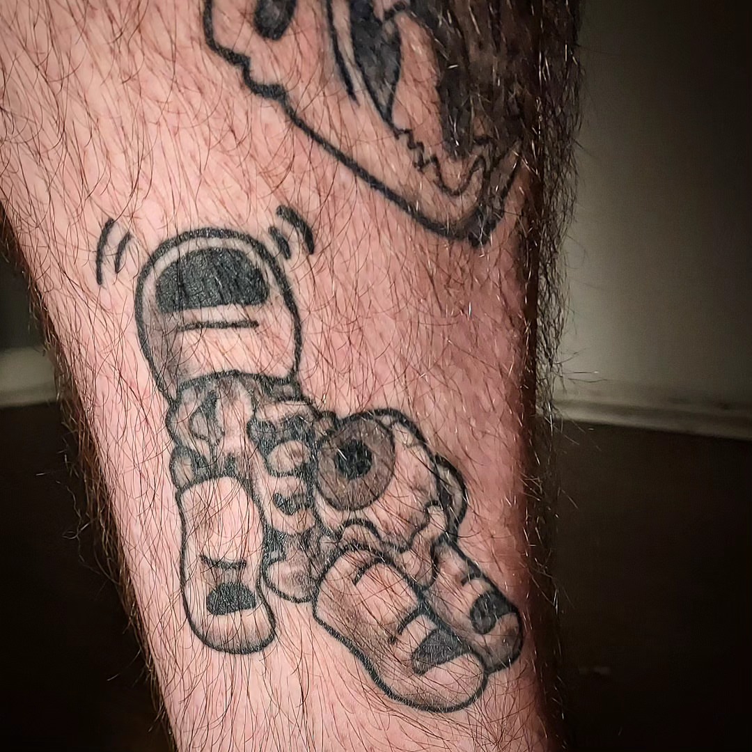 Wall-e black and grey tattoo on the forearm by Spike Cameron