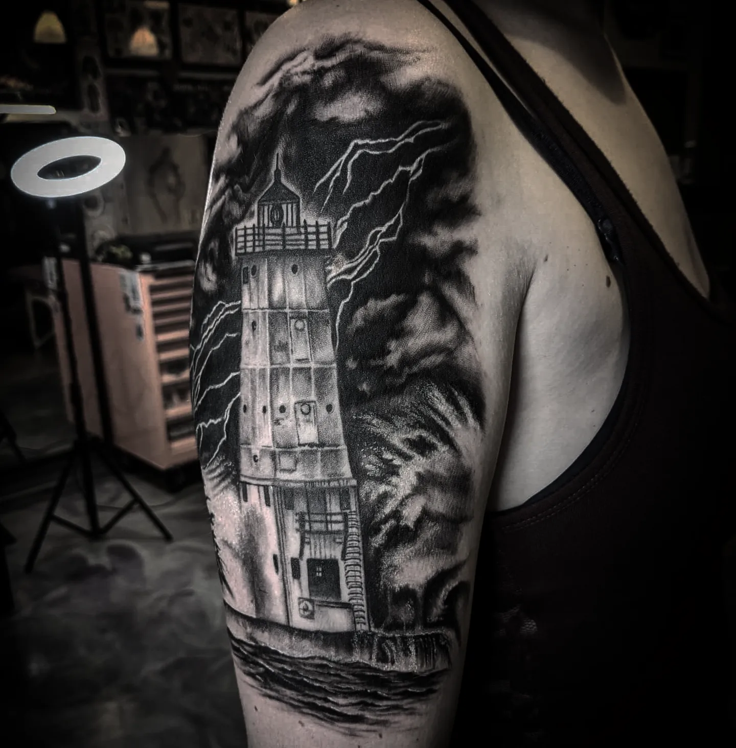 Lighthouse realism tattoo on the shoulder by Krista Mc