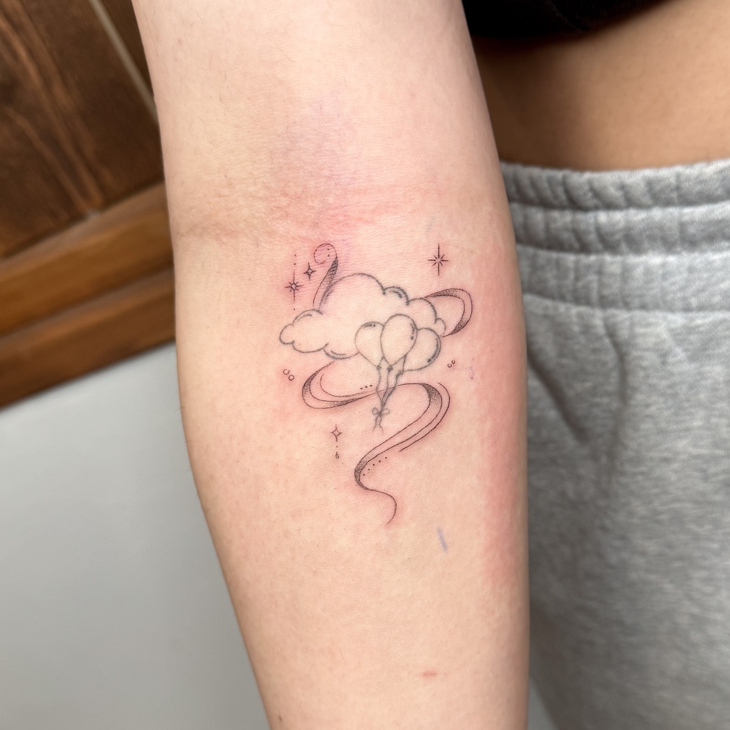 Balloons and cloud dotwork tattoo on the forearm by INK by CEE