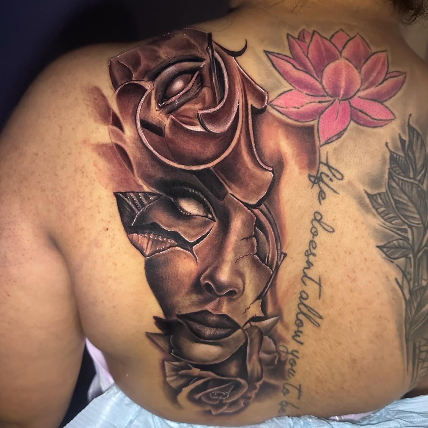 Woman's face with roses realism tattoo on the back by jersey ink tattoos, Elizabeth, New Jersey