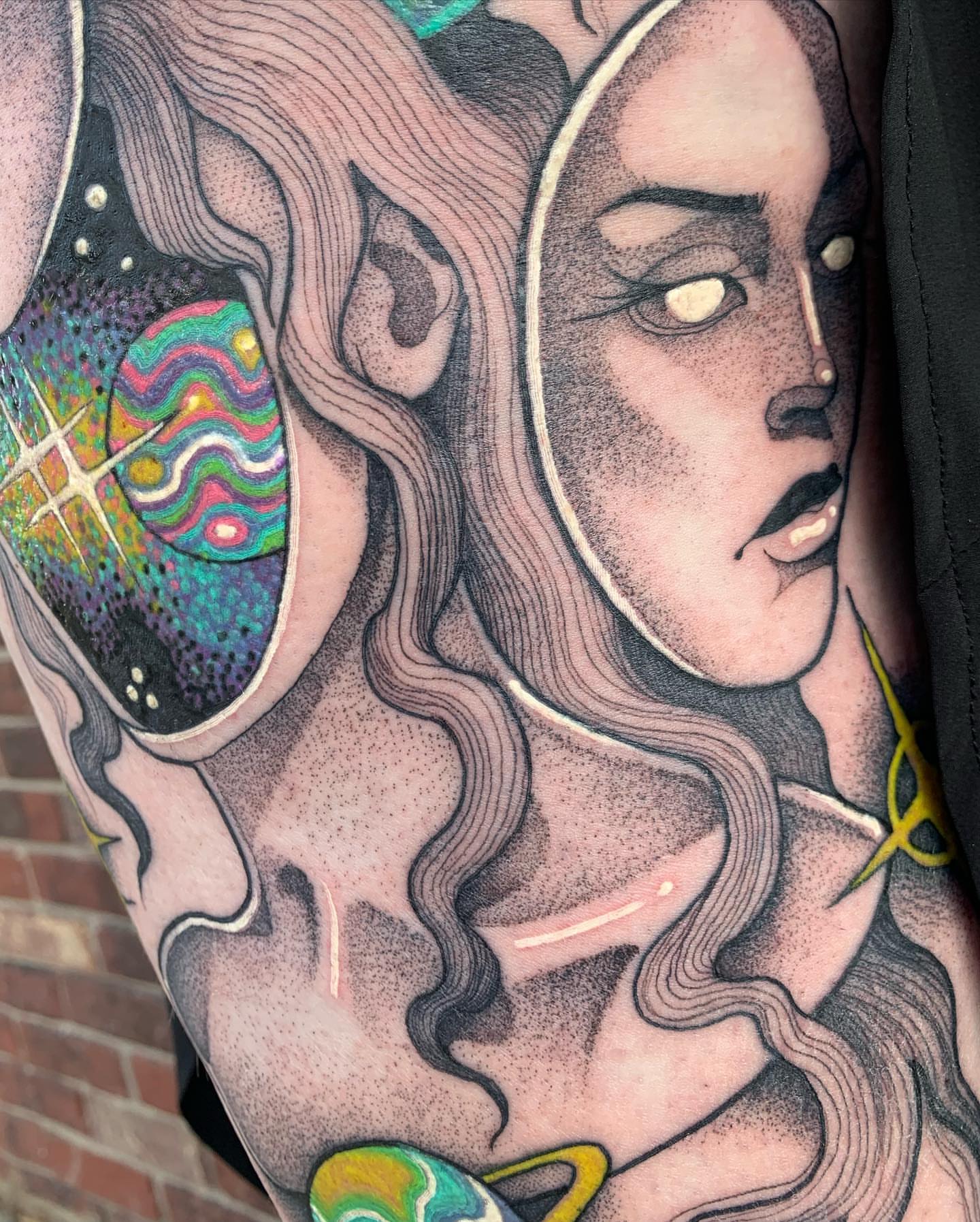 Abstract woman dotwork tattoo on the upper arm by Carly Zehring