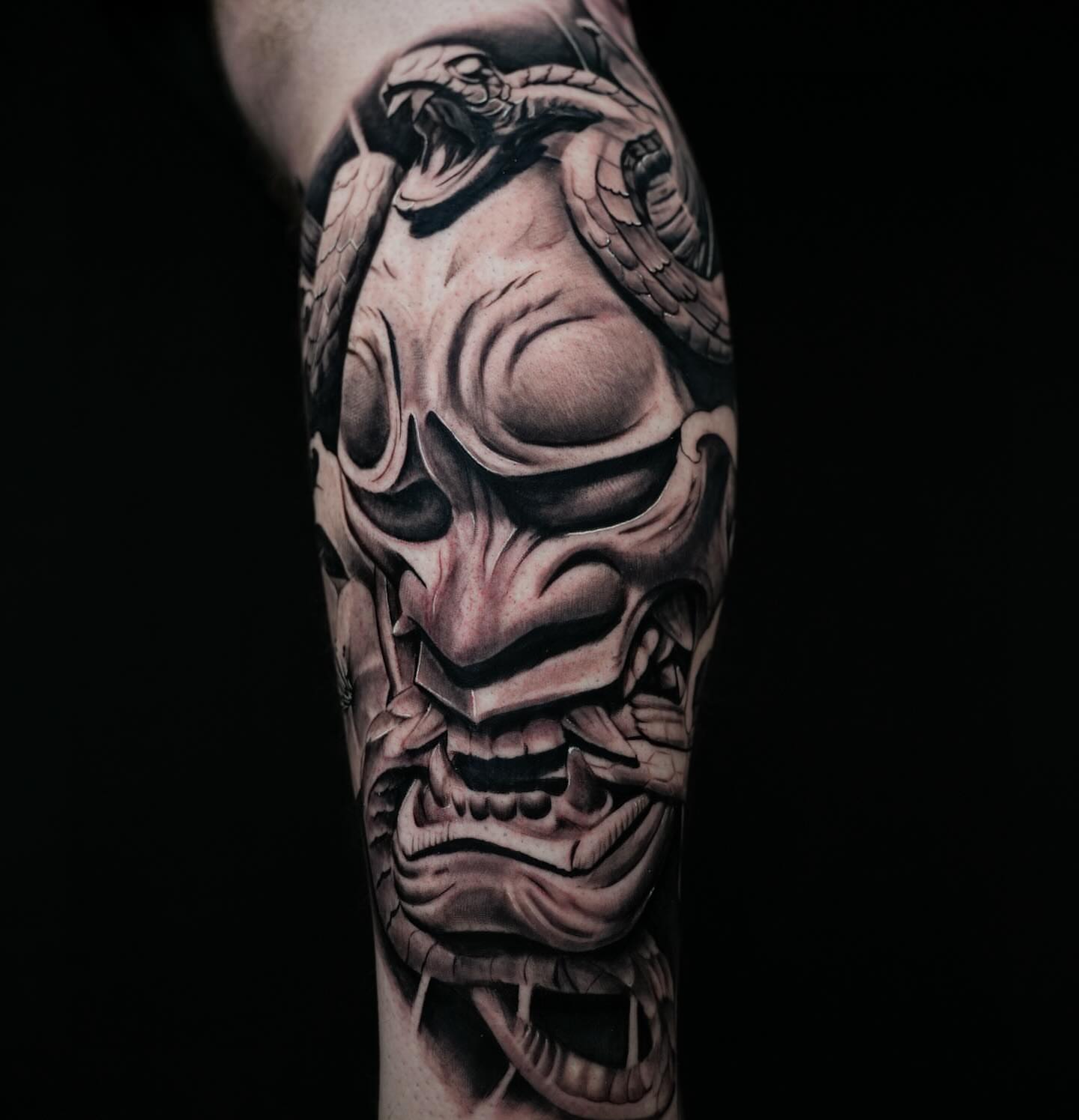 Skull with snake realism tattoo on the forearm by Anthony Macias
