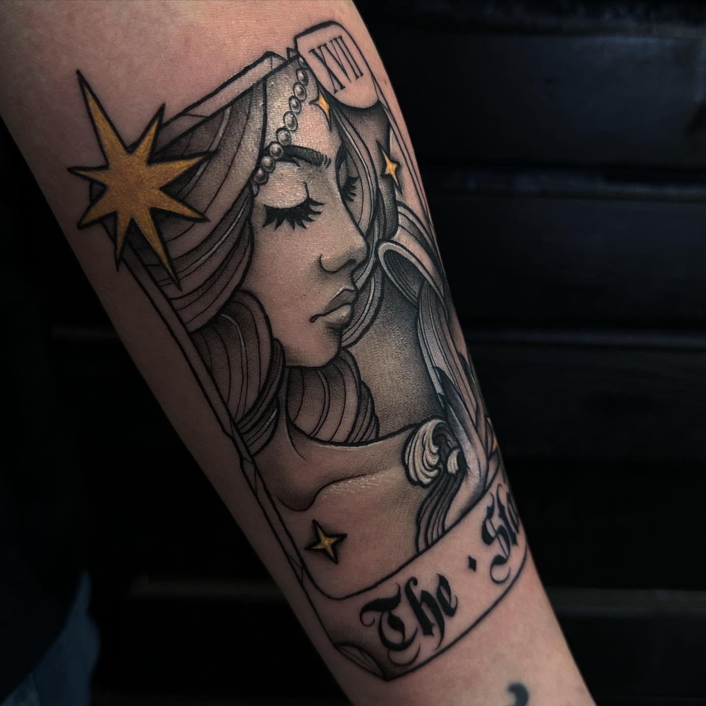Woman with stars American traditional tattoo on the forearm by audi