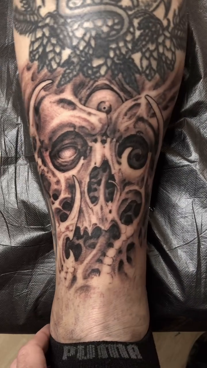 Biomechanical skull dark realism tattoo by Oak Adams