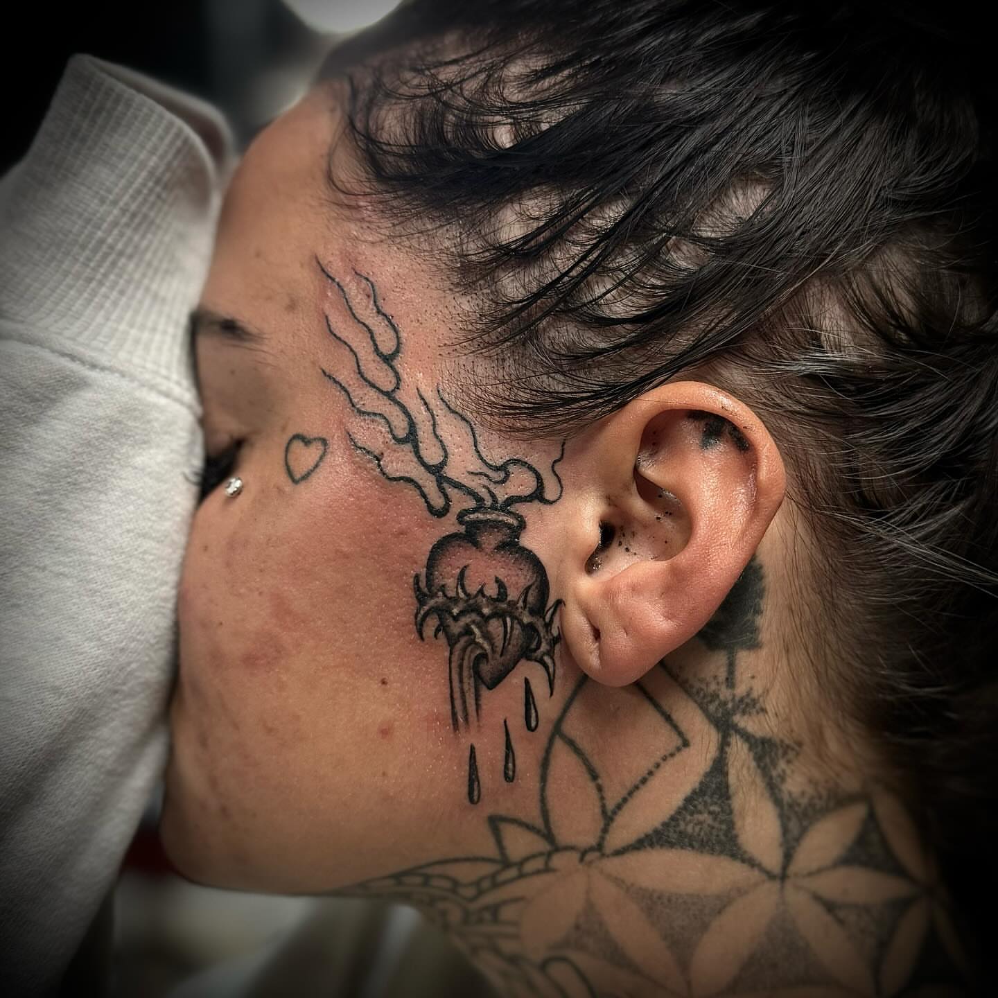 Heart with smoke black and grey tattoo on the neck by Troy Mort, Altoona, Pennsylvania