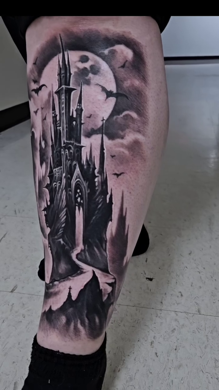 Gothic castle under a full moon dark realism tattoo by Tyler Malek