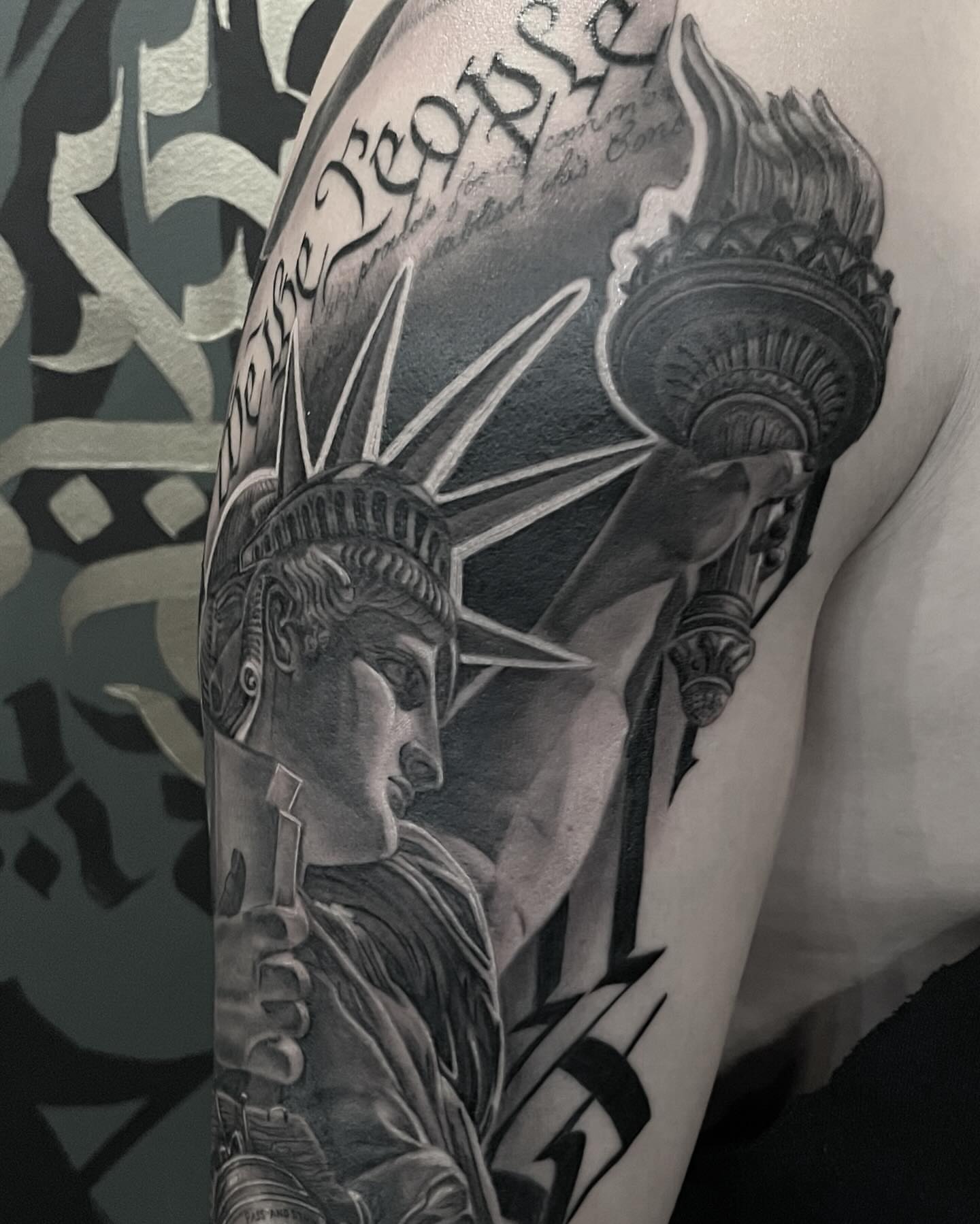 Statue of liberty realism tattoo on the forearm by mike hudson