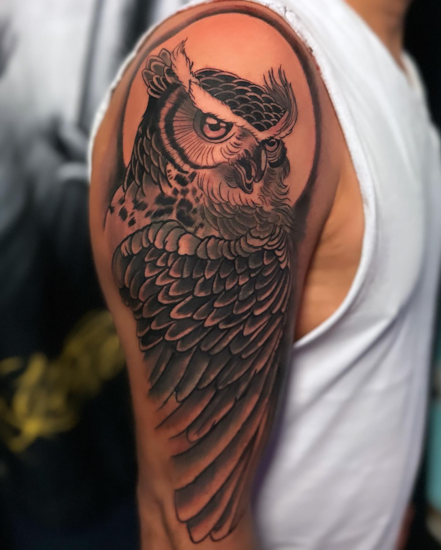 Owl realism tattoo on the upper arm by Alberto Ramirez
