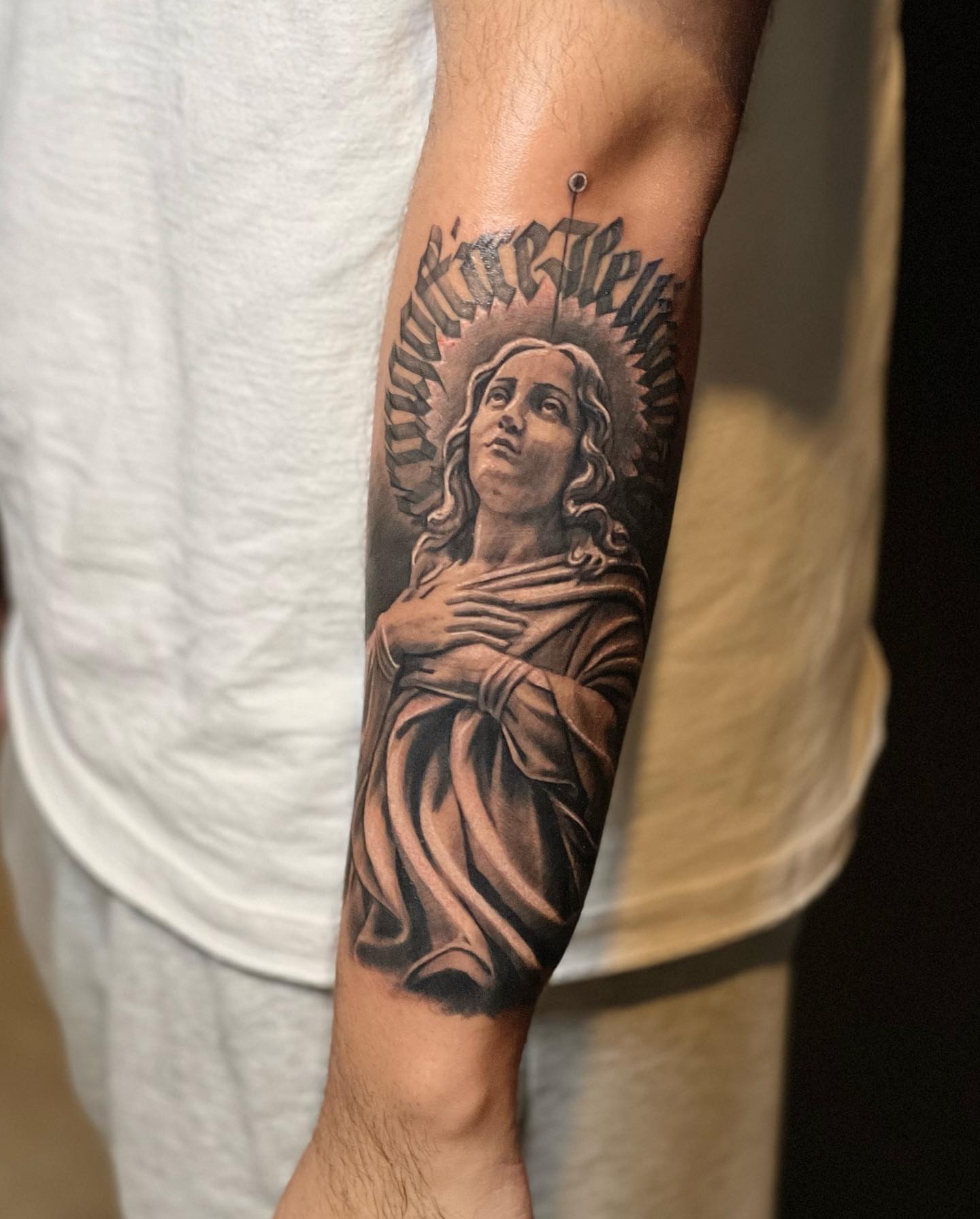 Religious angel realism tattoo on the forearm by Luis Meneses