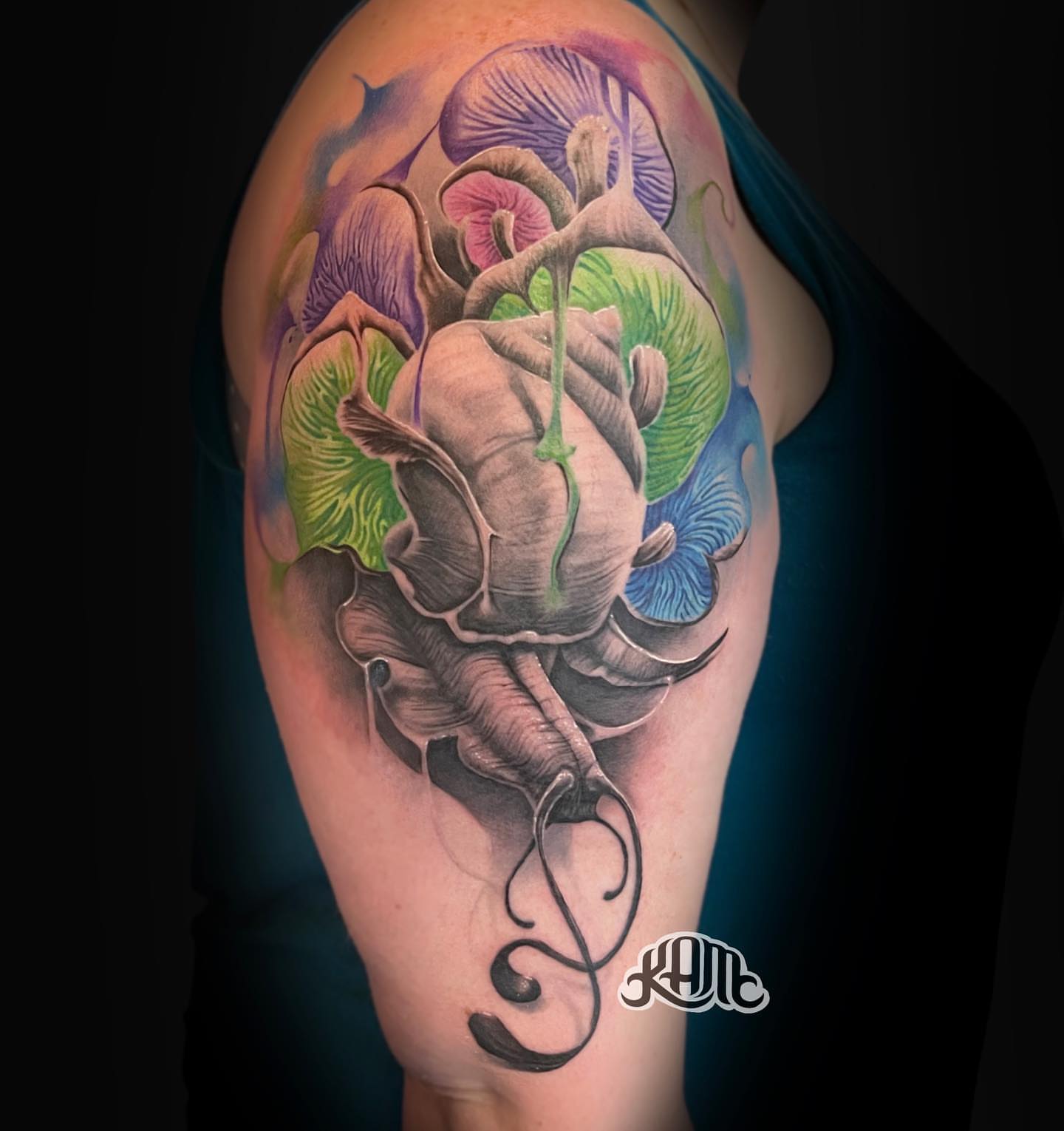 Octopus and flowers realism tattoo on the shoulder by Keith (KAM) Miller