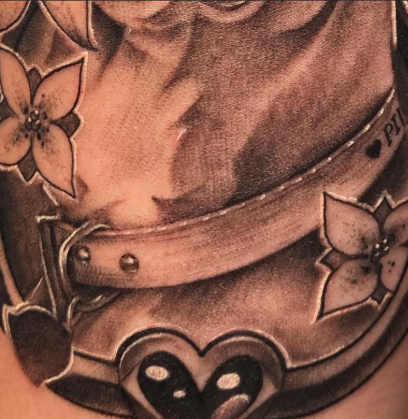 Belt and floral motifs black and grey tattoo on the torso by Saint Jimmy