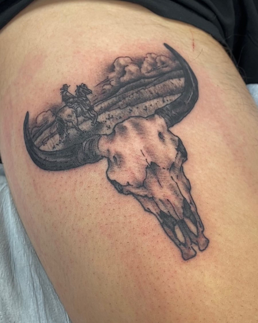 Bull skull with rider realism tattoo on the thigh by Jesse Ortega