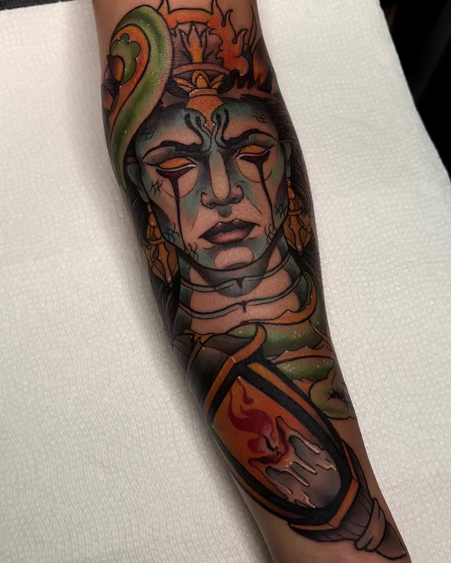 Deity with snake American traditional tattoo on the forearm by E