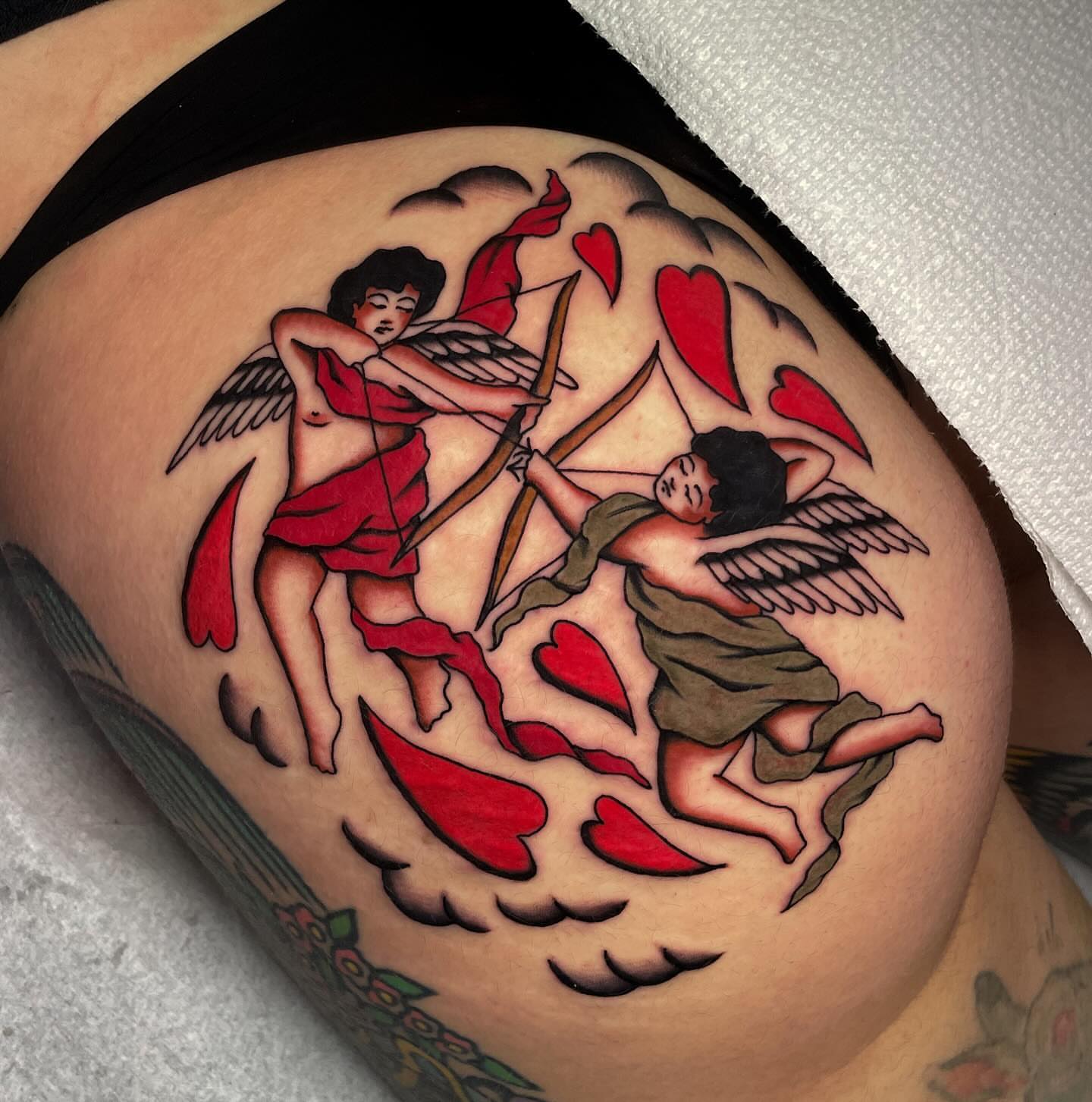 Angels and hearts American traditional tattoo on the thigh by Toulouse Noble, Portland, Oregon