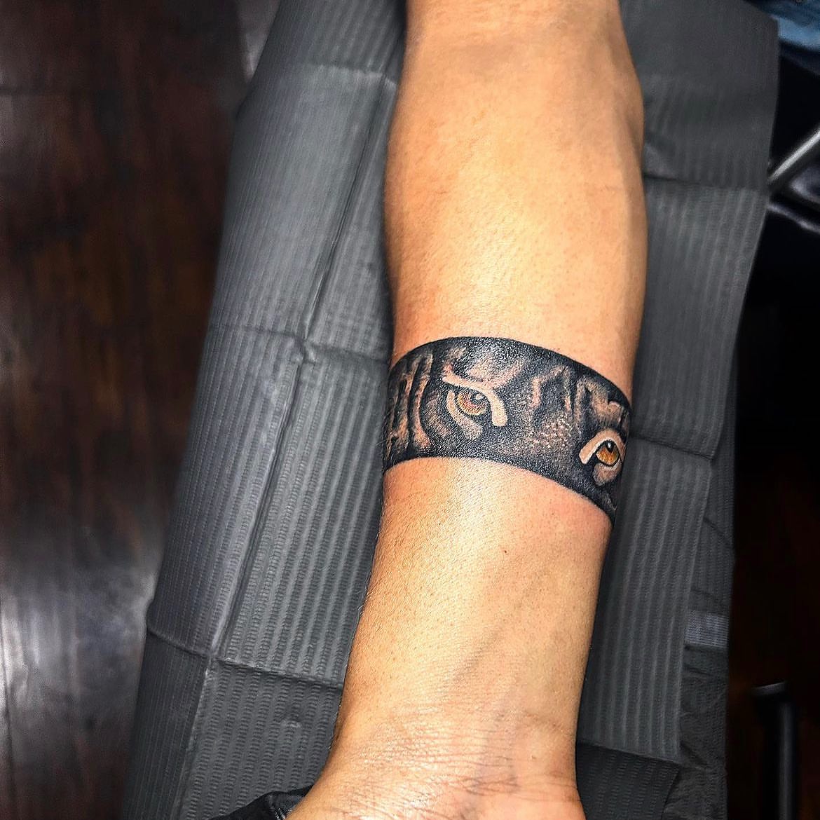 Owl black and grey tattoo on the forearm by Visionary Tattoos