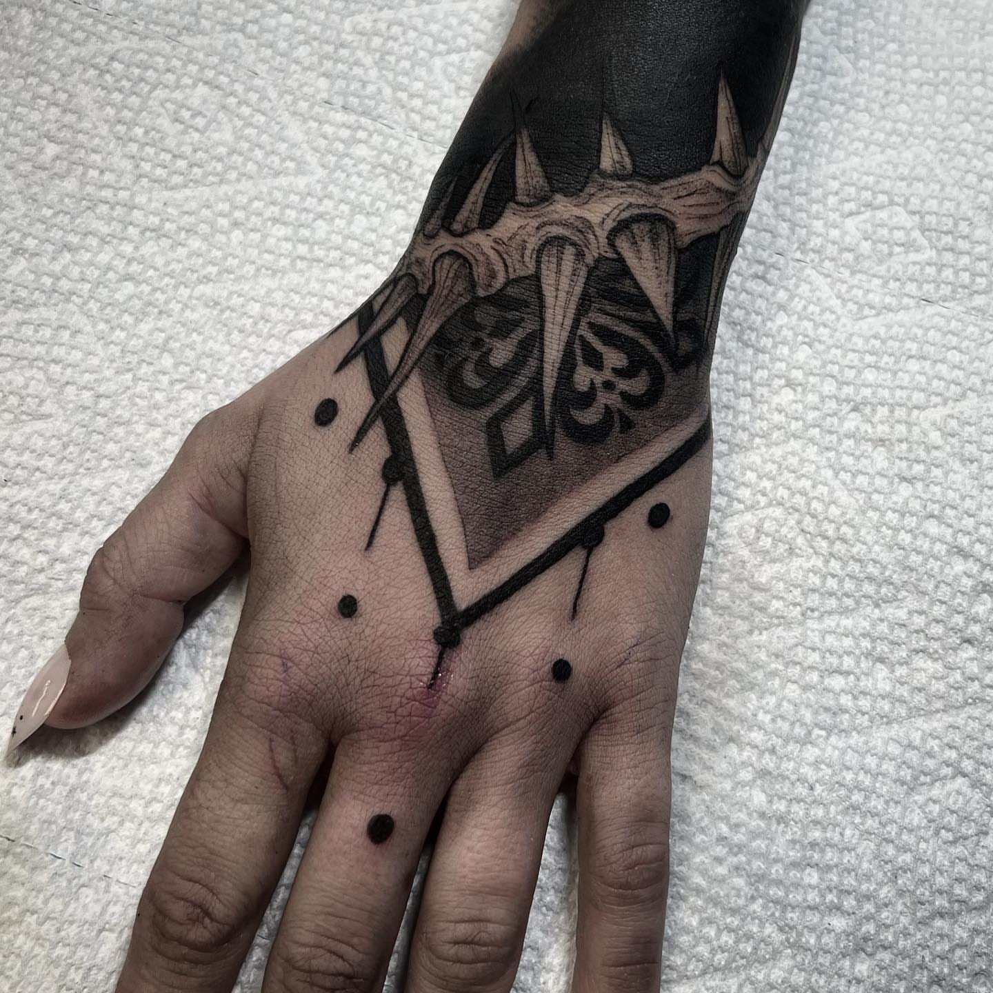 Jewelry black and grey tattoo on the hand by Briana Walker
