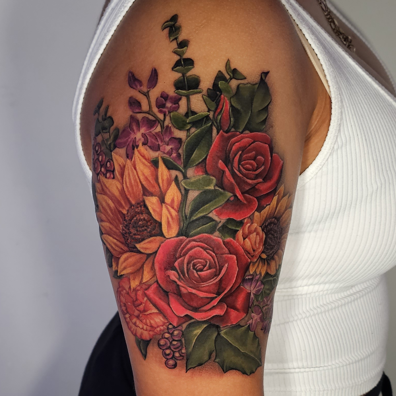 Floral bouquet realism tattoo on the upper arm by Dallas Tattoo Artist Erik Espinoza