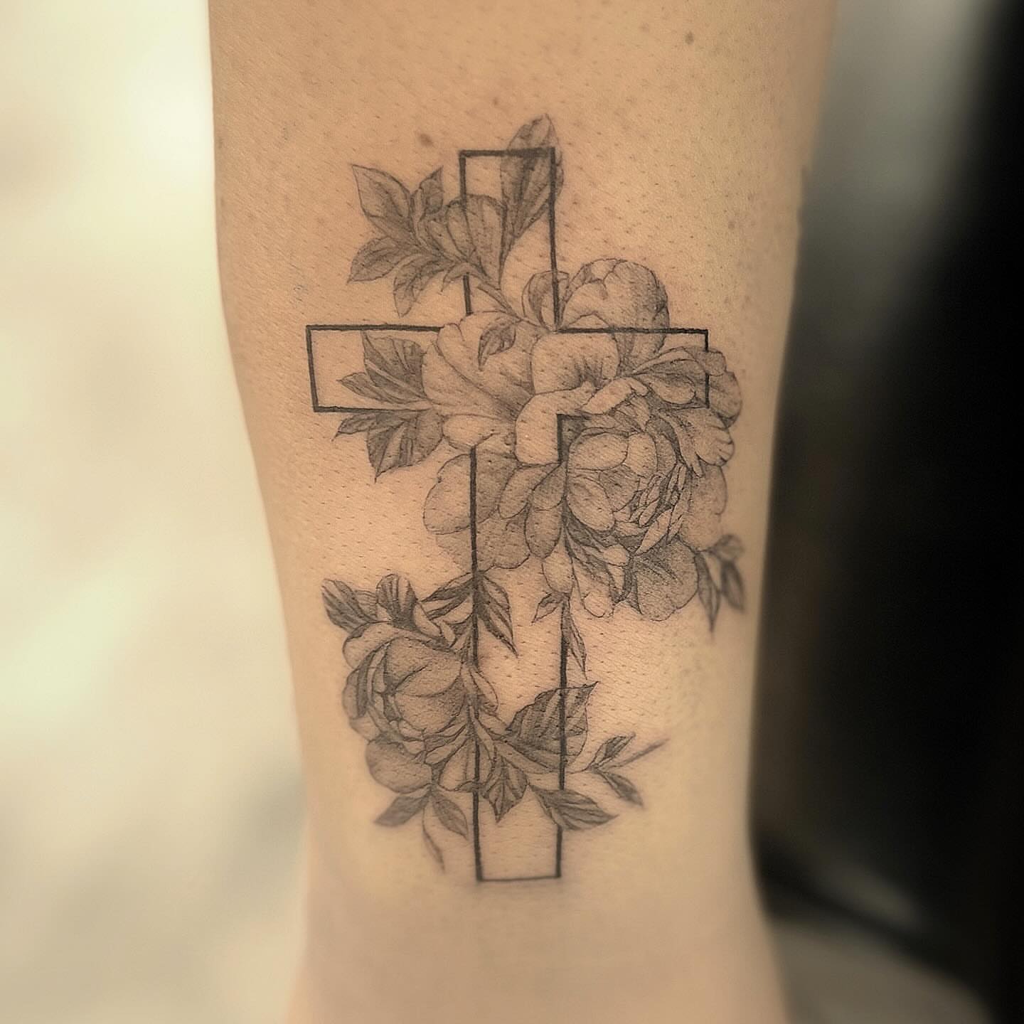 Cross with roses realism tattoo on the forearm by Jocelyn