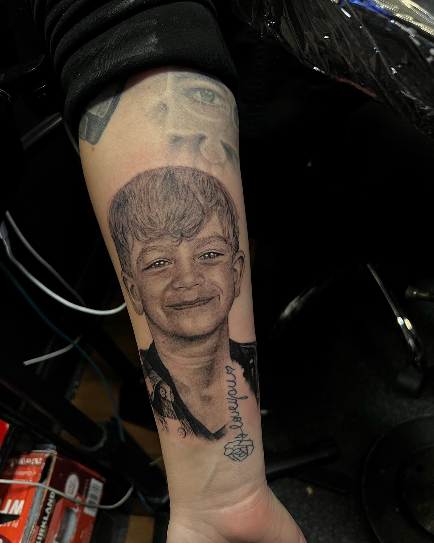 Portrait of a young boy realism tattoo on the forearm by JT Ink