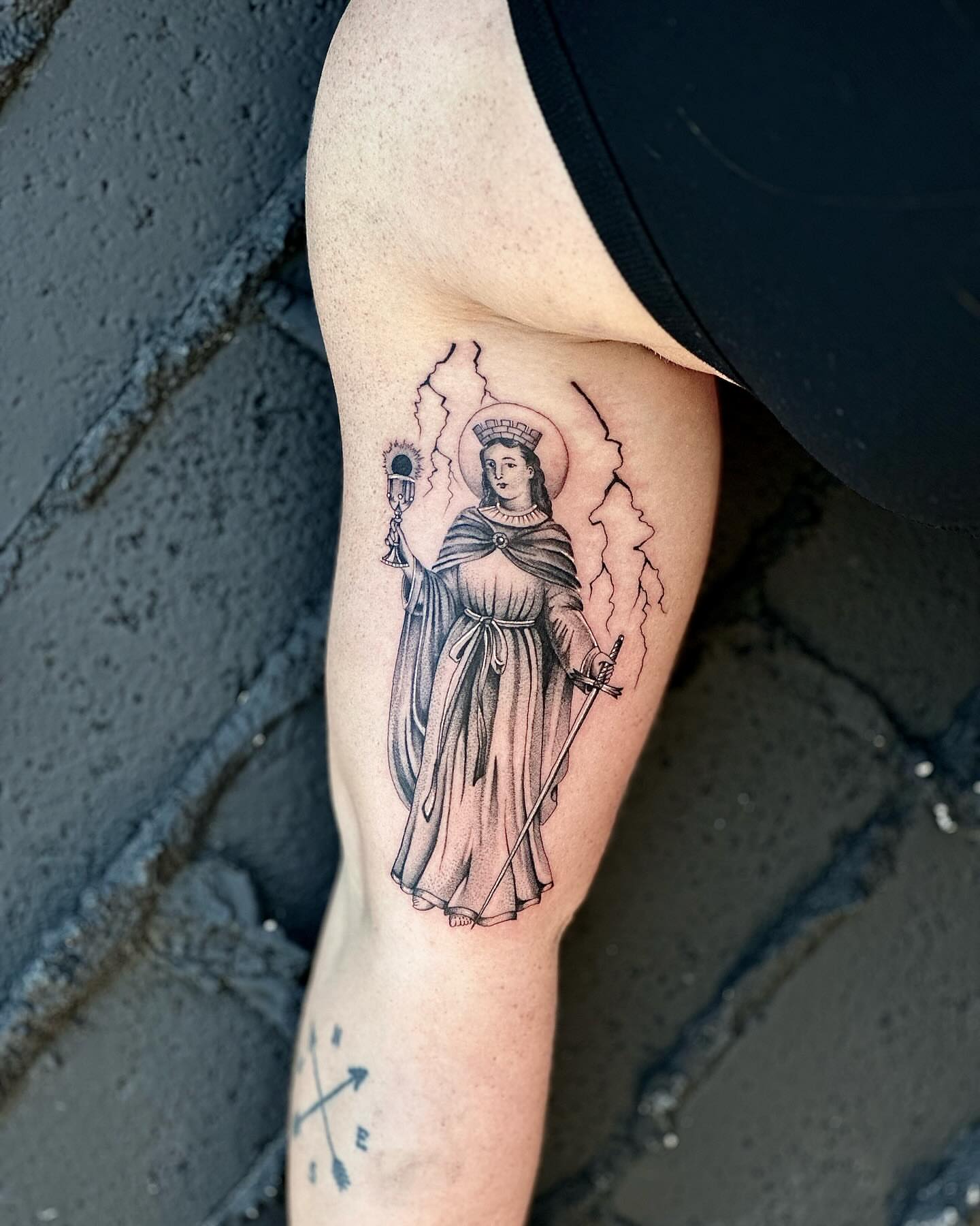 Religious figure black and grey tattoo on the forearm by Fine line tattoo San Diego, San Diego, California