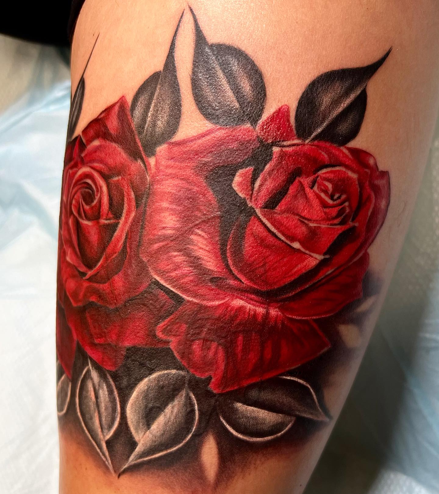Red roses realism tattoo on the forearm by The Tattoo Saint- DMV Tattoo Artist, Hyattsville, Maryland