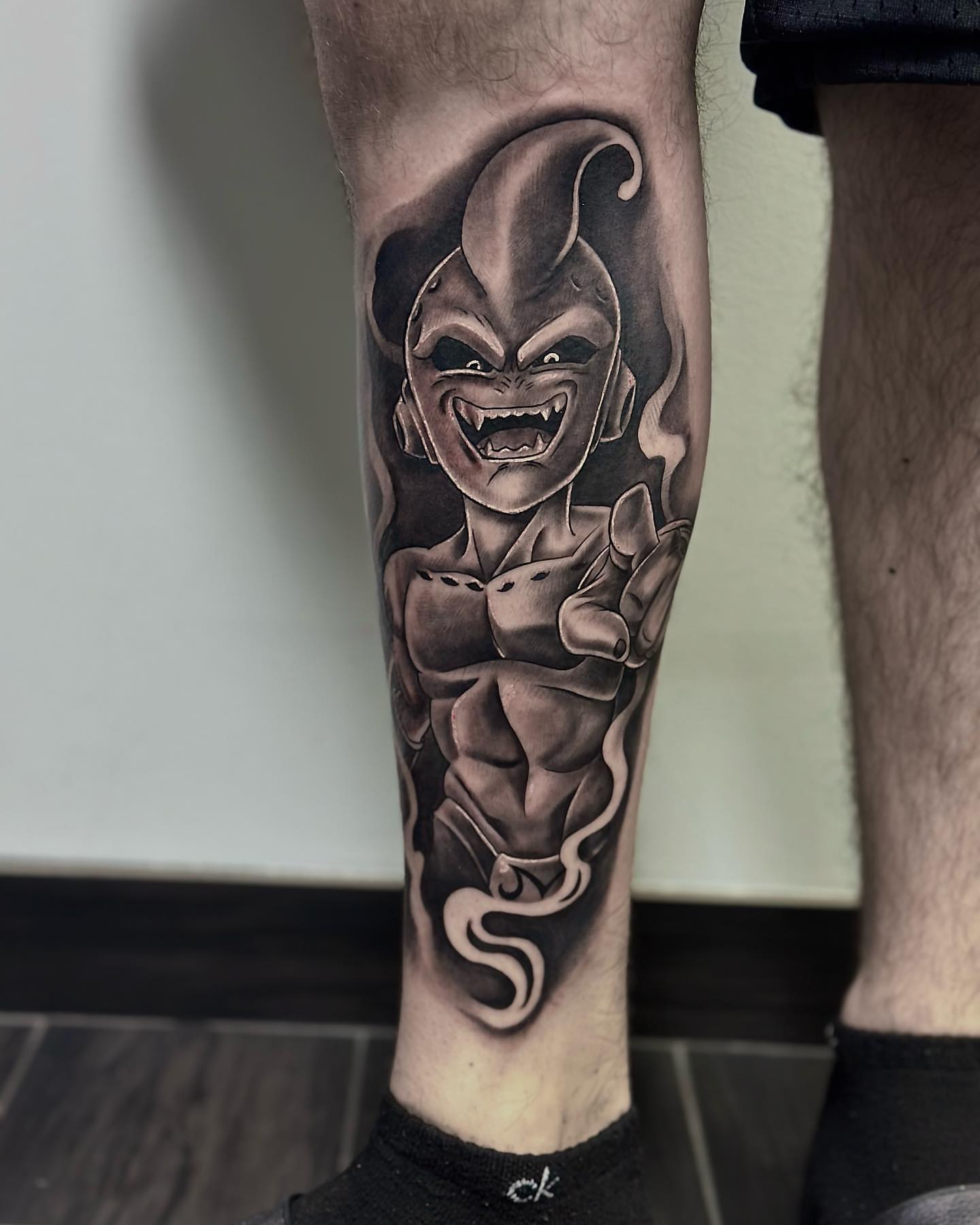 Jester character black and grey tattoo on the forearm by Aaron Watson