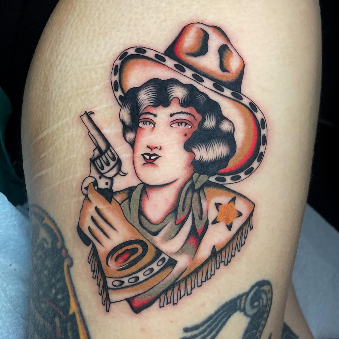 Cowgirl American traditional tattoo on the thigh by Toulouse Noble, Portland, Oregon