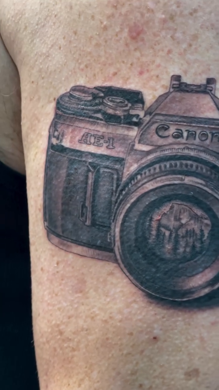 Vintage camera realism tattoo by Ian Vanderwerff