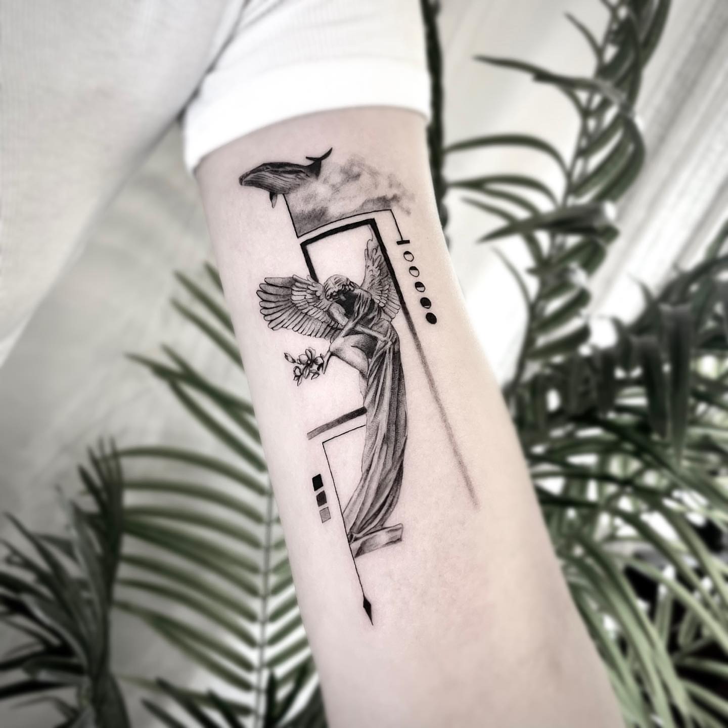 Angel with wings black and grey tattoo on the forearm by Seraph Geometry
