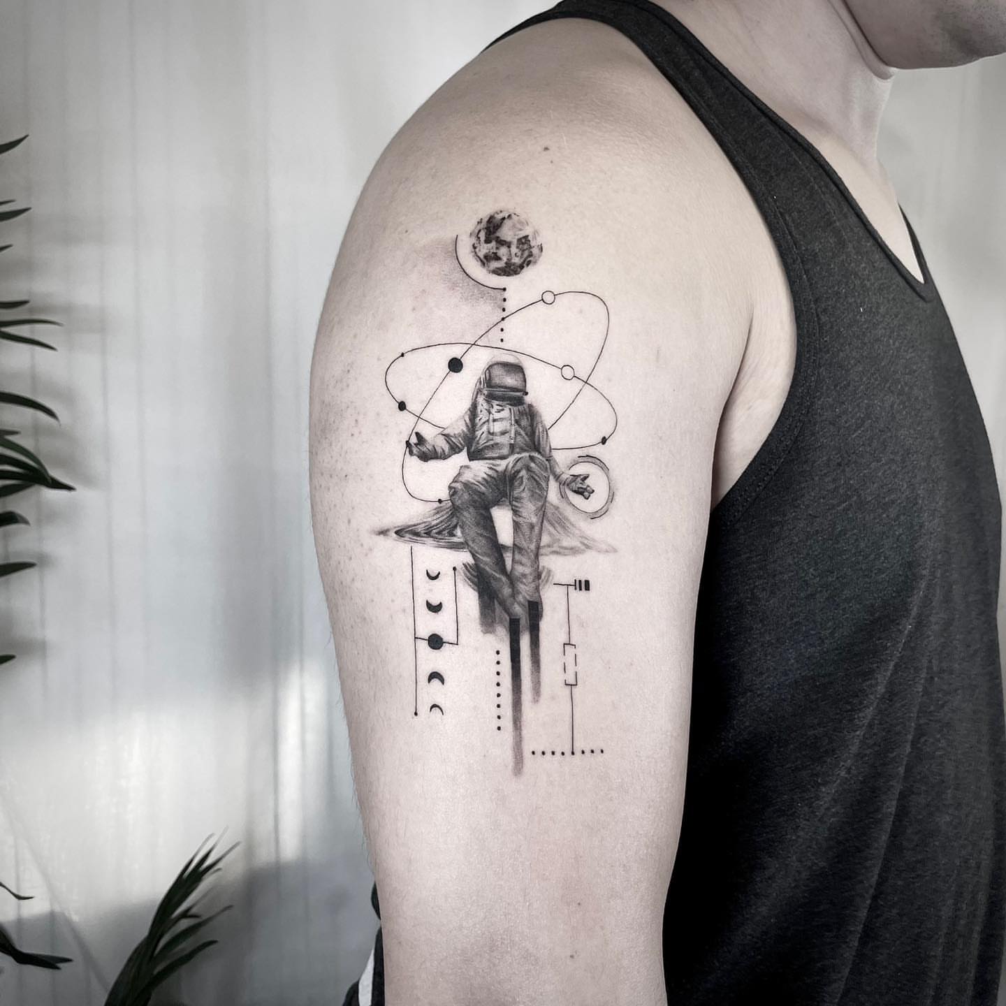 Astronaut realism tattoo on the shoulder by Seraph Geometry