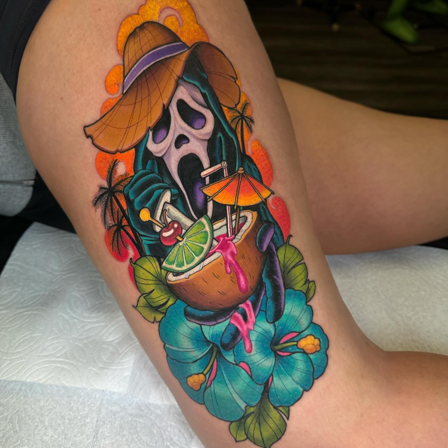 Skull with cocktail new school tattoo on the thigh by Jon Leighton