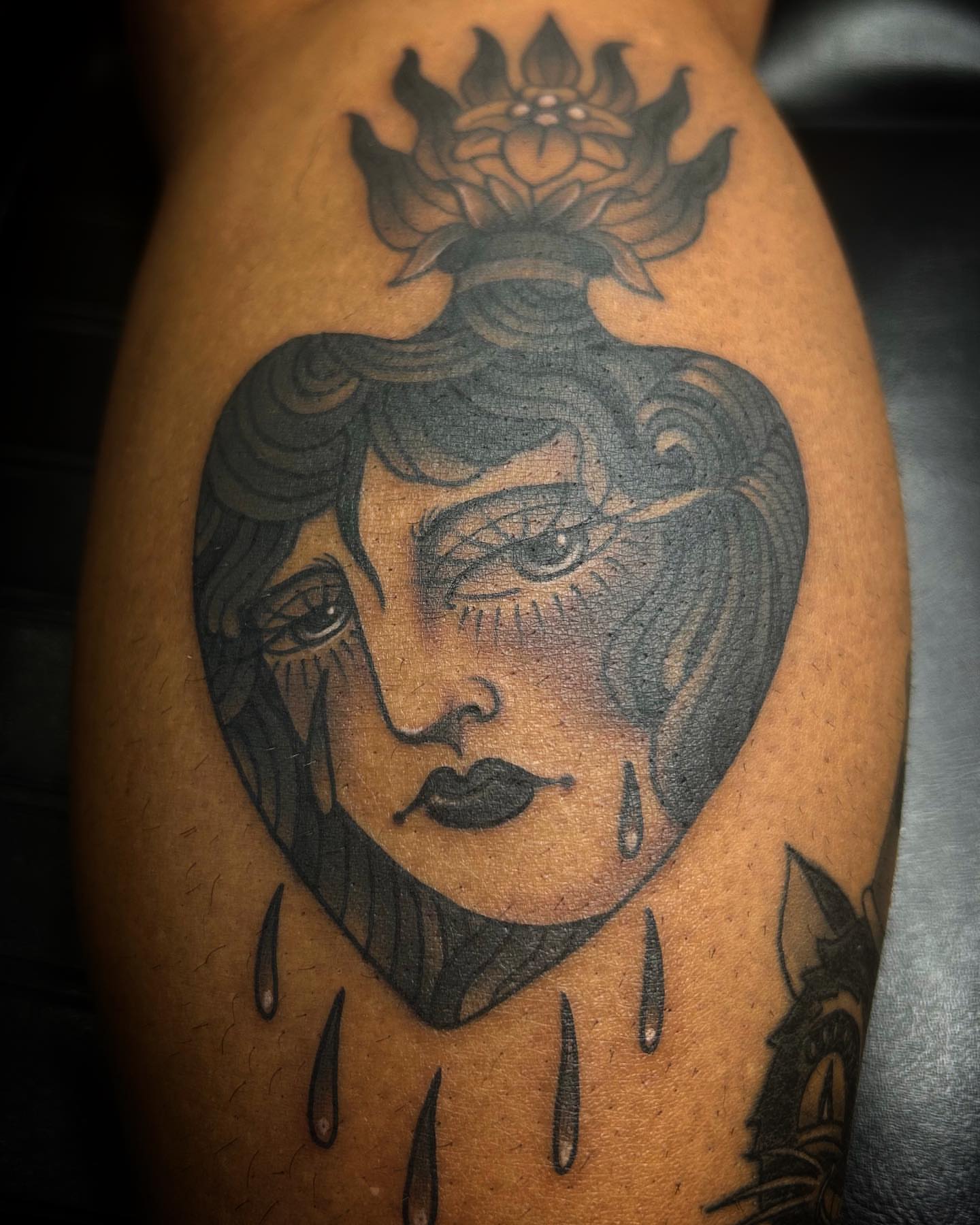 Woman's face with tears American traditional tattoo on the forearm by Samantha C, Bremerton, Washington