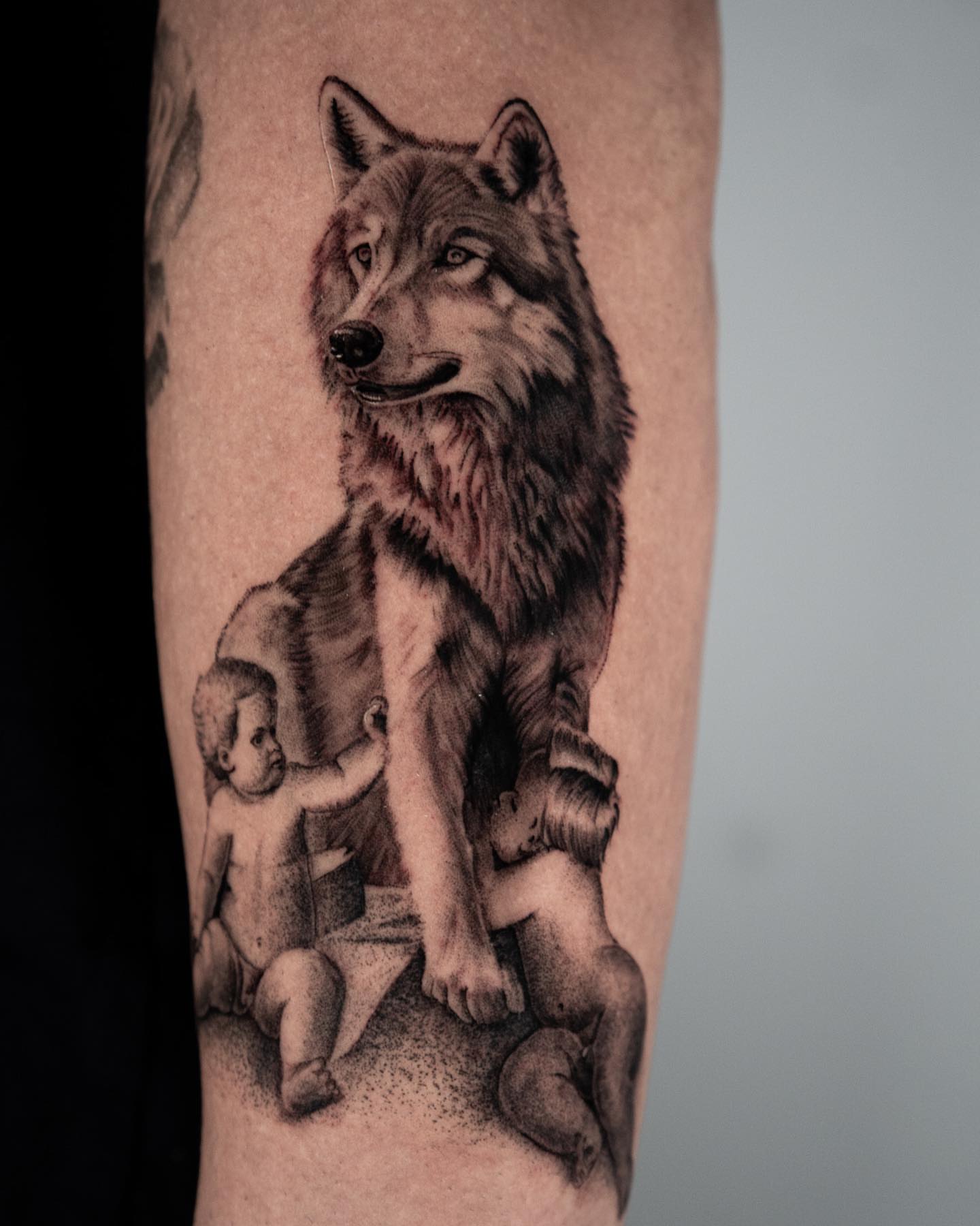 Wolf and children dotwork tattoo on the forearm by Douglas Santos