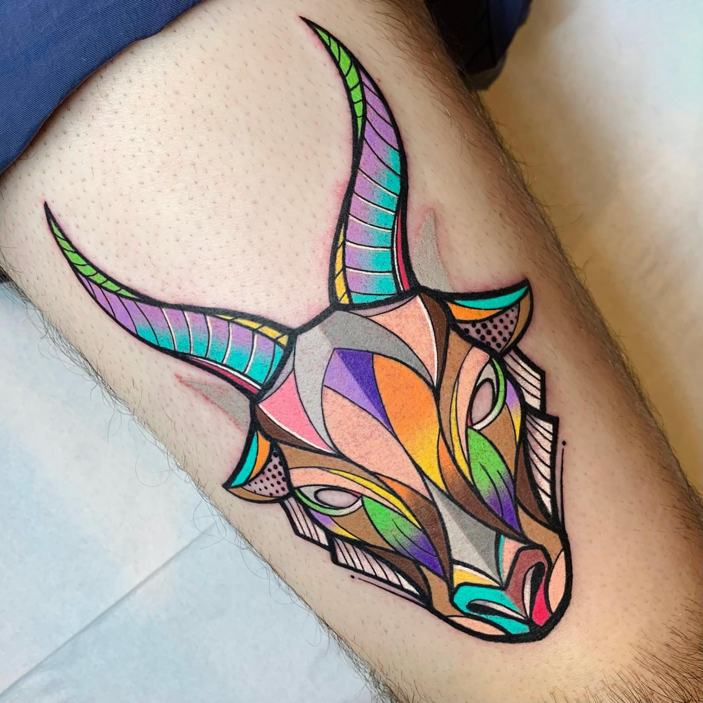 Bull head geometric tattoo on the thigh by hurjaesae