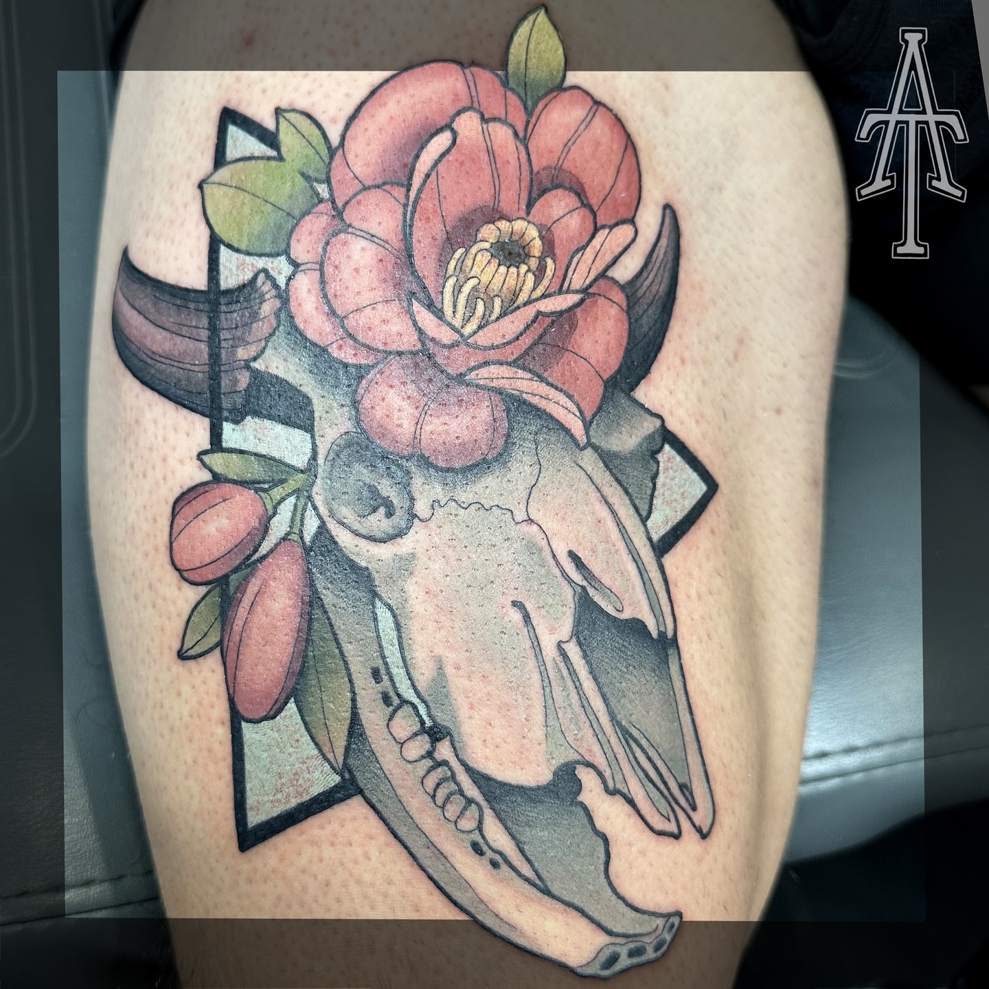 Skull and flower American traditional tattoo on the thigh by Chris Dobransky
